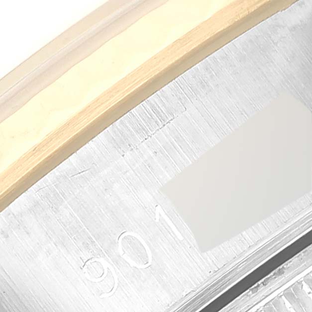 This close-up image shows a part of the bezel and band of a Rolex Date 69173 Women's Steel and Gold (two tone) Champagne Dial 69173 Women's Steel and Gold (two tone) Champagne Dial model watch, highlighting its metallic texture and engraving.