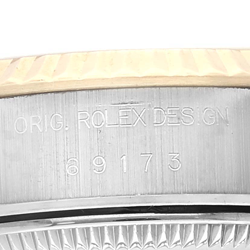 This close-up image shows the case side and bezel part of a Rolex Datejust 69173 Women's Steel and Gold (two tone) Champagne Dial 69173 Women's Steel and Gold (two tone) Champagne Dial watch, highlighting the model number "69173."