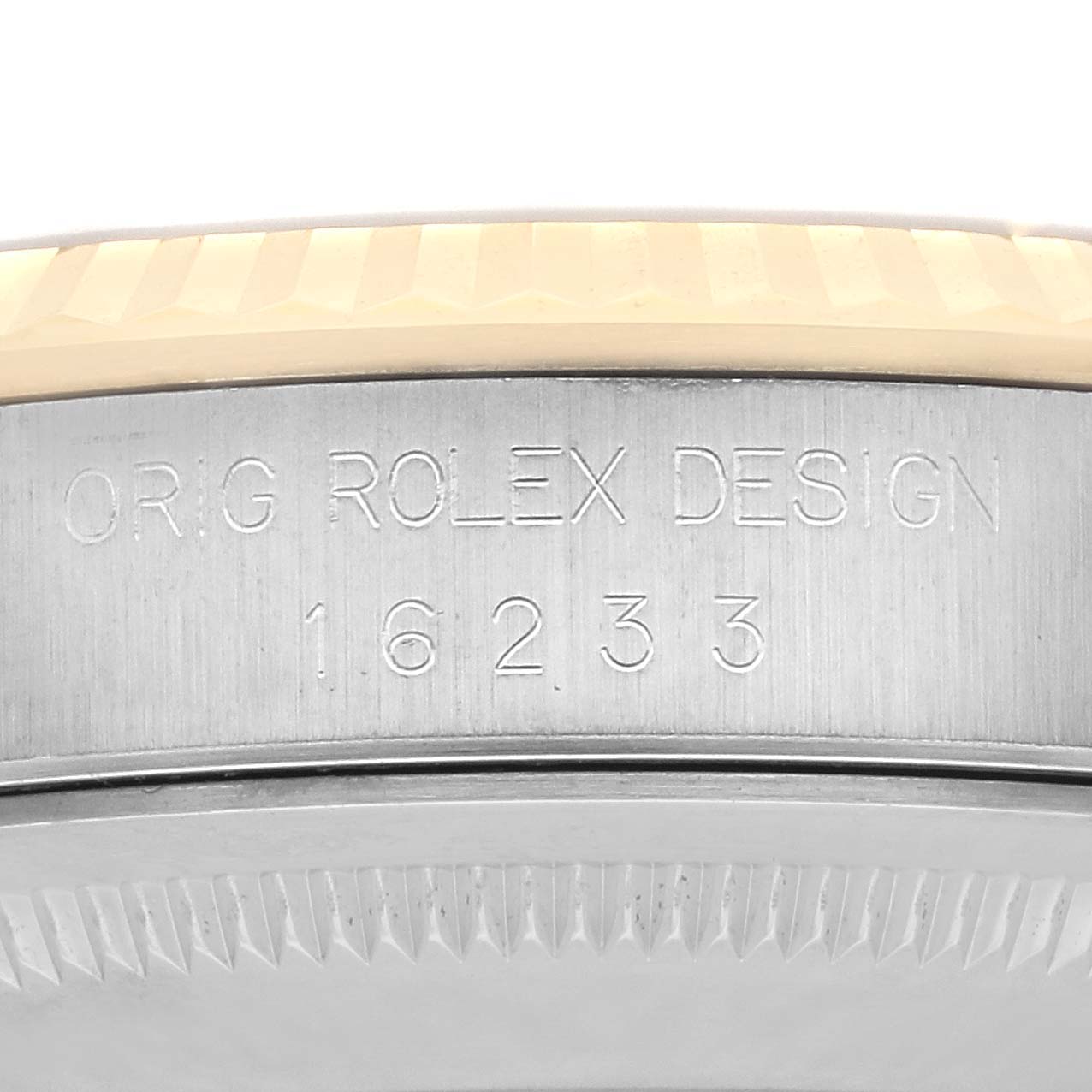 The image shows a close-up of the Rolex Datejust 16233 Men's Steel and Gold (two tone) Champagne Dial 16233 Men's Steel and Gold (two tone) Champagne Dial’s case side, displaying "ORIG ROLEX DESIGN" and the model number 16233.