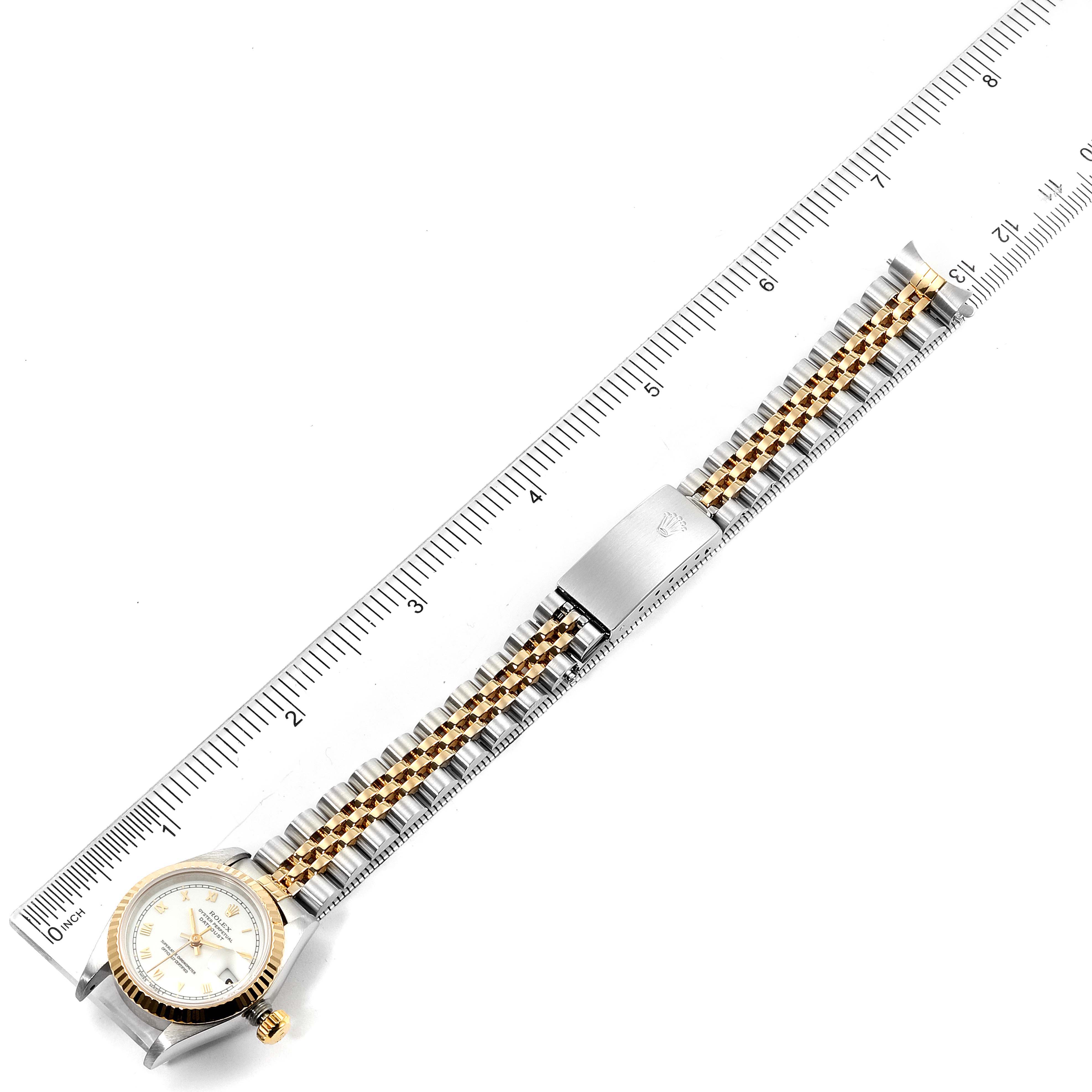 The image shows a Rolex Datejust 69173 Women's Steel and Gold (two tone) White Dial 69173 Women's Steel and Gold (two tone) White Dial watch laid flat with a ruler for scale, highlighting the watch face and bracelet.