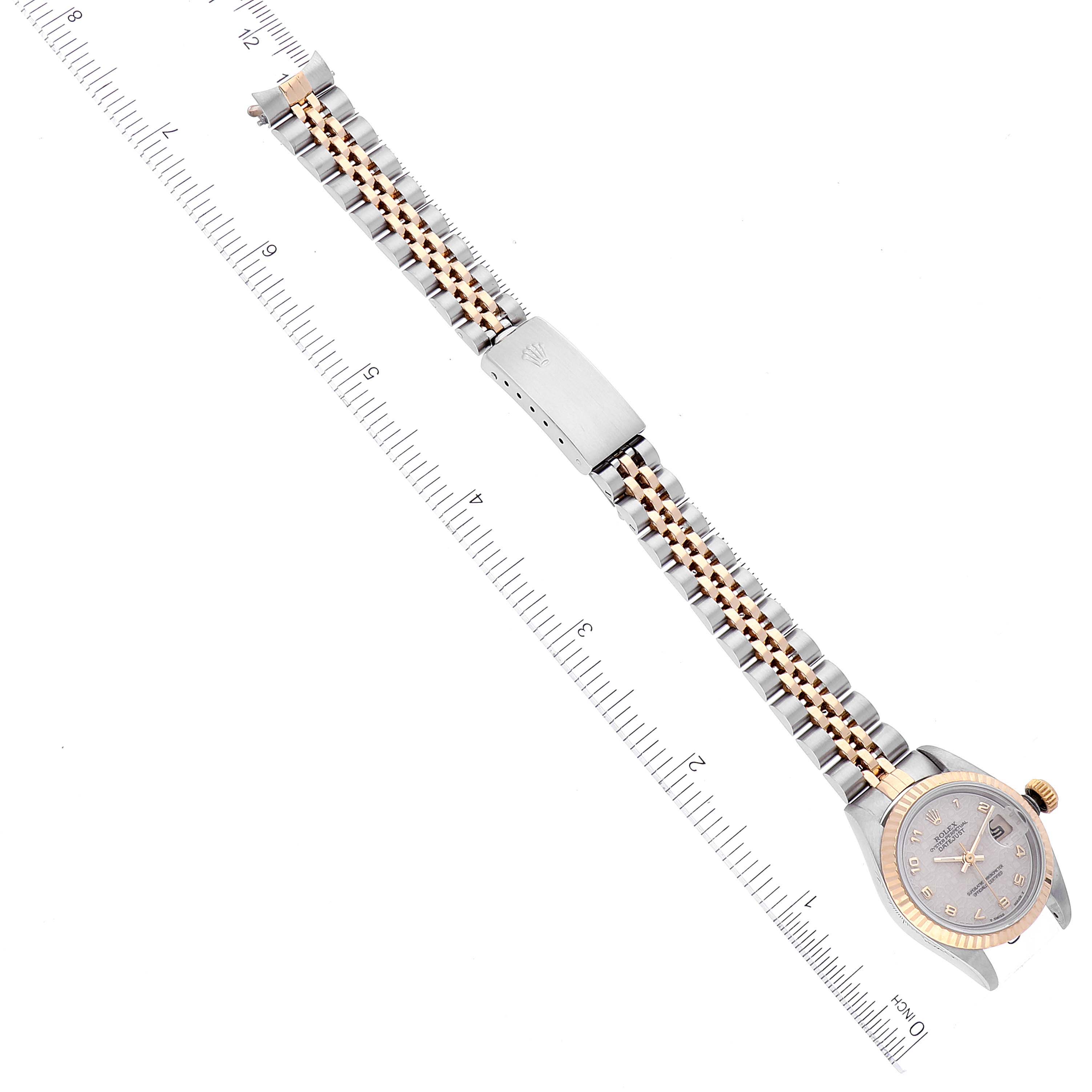 The image shows a top-down view of a Rolex Datejust 69173 Women's Steel and Gold (two tone) Beige Dial 69173 Women's Steel and Gold (two tone) Beige Dial watch, highlighting its face, bezel, bracelet, and clasp alongside a measuring ruler.