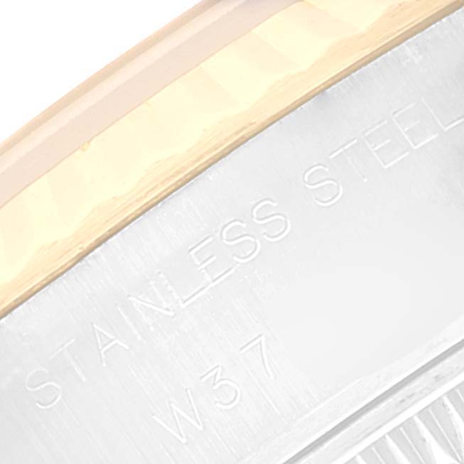 The image shows a close-up of the side case and markings of a Rolex Datejust 69173 Women's Steel and Gold (two tone) Beige Dial 69173 Women's Steel and Gold (two tone) Beige Dial watch, highlighting its "STAINLESS STEEL" engraving.