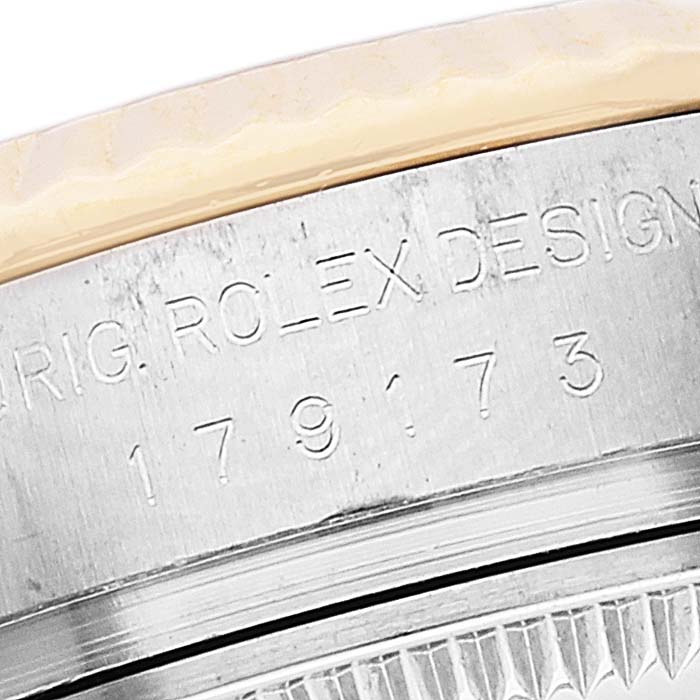 This close-up image shows the side engraving of the Rolex Datejust 179173 Women's Steel and Gold (two tone) Mother of Pearl Dial 179173 Women's Steel and Gold (two tone) Mother of Pearl Dial model, highlighting the serial number.