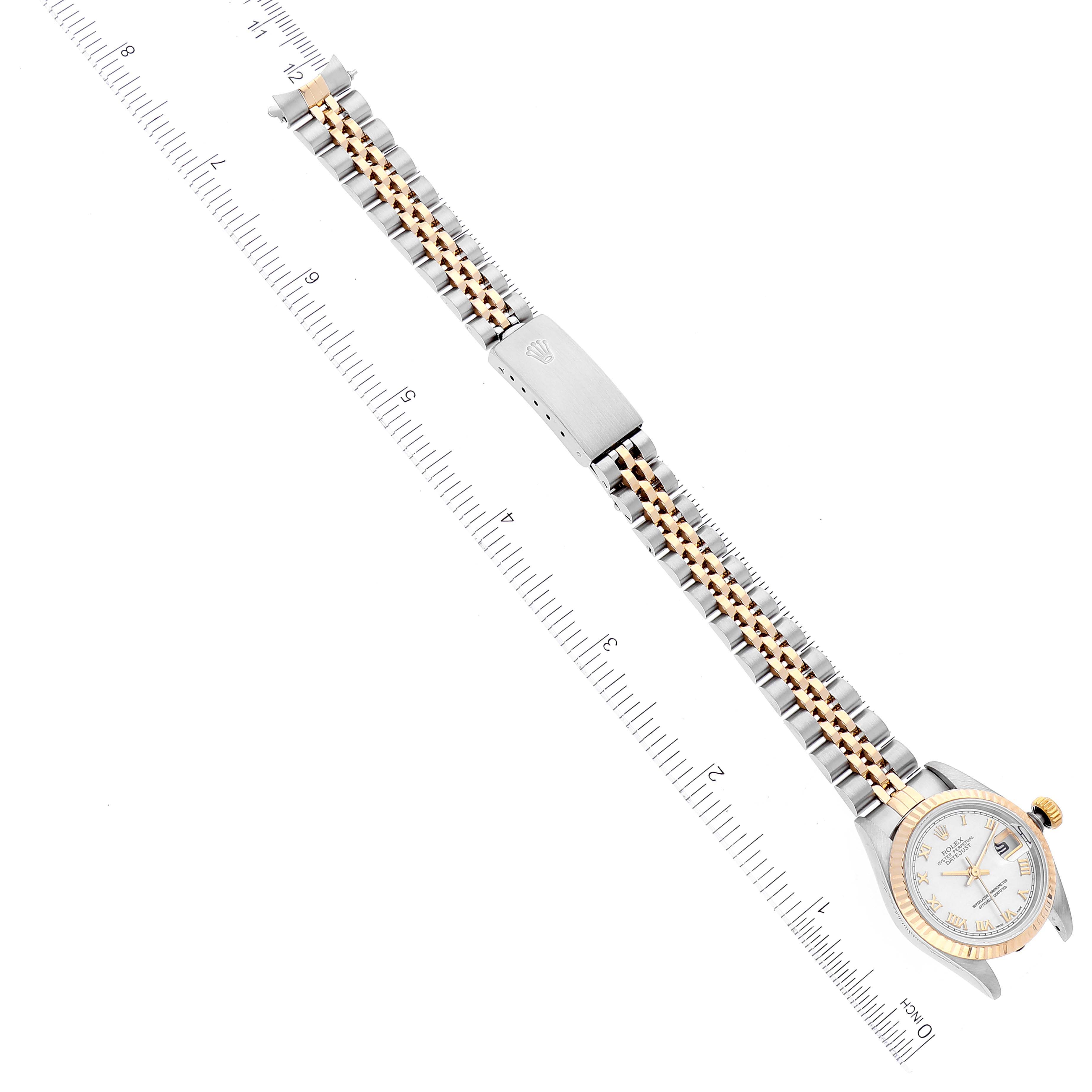 This image shows a top-down view of a Rolex Datejust 69173 Women's Steel and Gold (two tone) Mother of Pearl Dial 69173 Women's Steel and Gold (two tone) Mother of Pearl Dial watch, featuring its bracelet and partially visible dial next to a ruler.