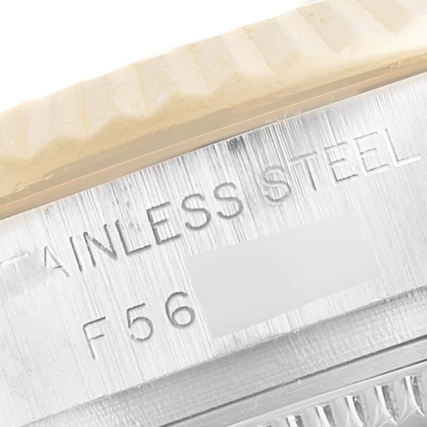 This close-up image of a Rolex Datejust 179173 Women
s Steel and Gold (two tone) Mother of Pearl Dial 179173 Women
s Steel and Gold (two tone) Mother of Pearl Dial watch shows part of the stainless steel case with engraved markings.