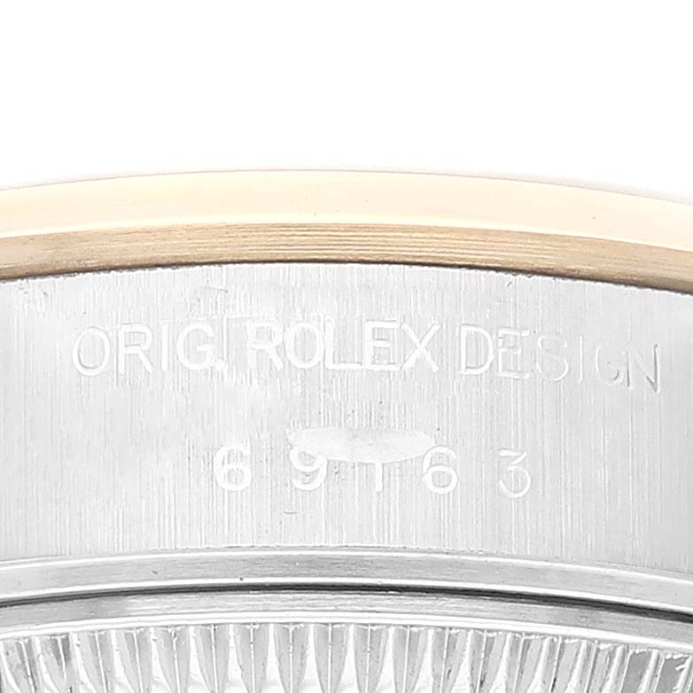 This image shows a close-up of the side engraving details on the bezel of a Rolex Datejust 69163 Women's Steel and Gold (two tone) White Dial 69163 Women's Steel and Gold (two tone) White Dial watch.