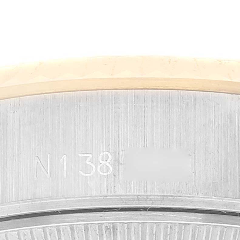 This close-up image shows the serial number engraved on the case back rim of the Rolex Datejust 69173 Women's Steel and Gold (two tone) White Dial 69173 Women's Steel and Gold (two tone) White Dial model.