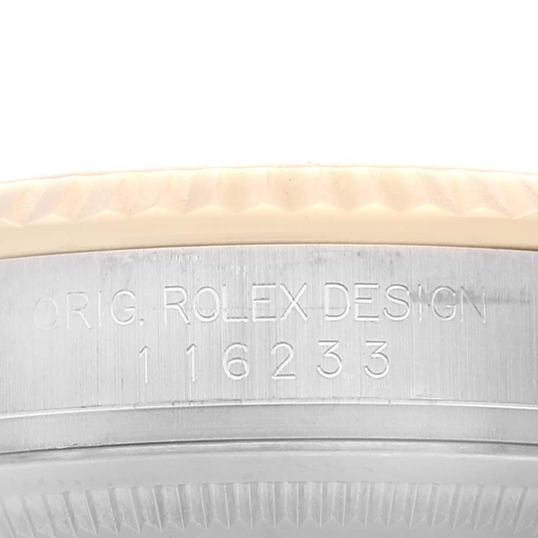 This close-up image shows the serial number and "Orig. Rolex Design" engraving on the side of the bezel of a Rolex Datejust 116233 Men's Steel and Gold (two tone) White Dial 116233 Men's Steel and Gold (two tone) White Dial watch.