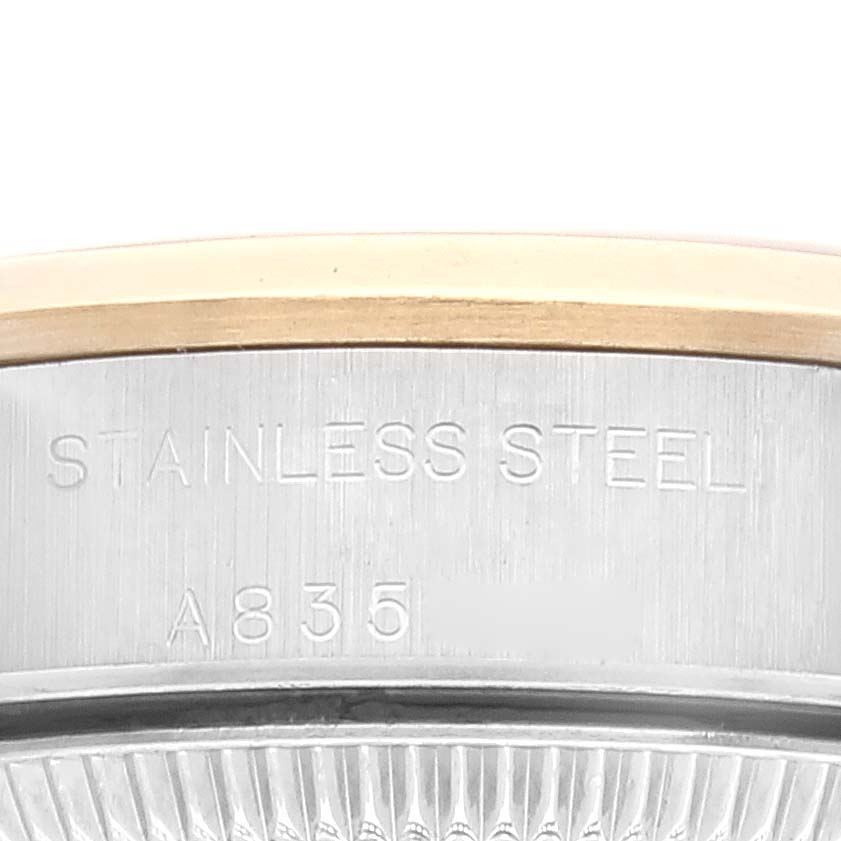This image shows a close-up side view of the casing of a Rolex Oyster Perpetual 76183 Women's Steel and Gold (two tone) Grey Dial 76183 Women's Steel and Gold (two tone) Grey Dial, highlighting stainless steel details and serial number.