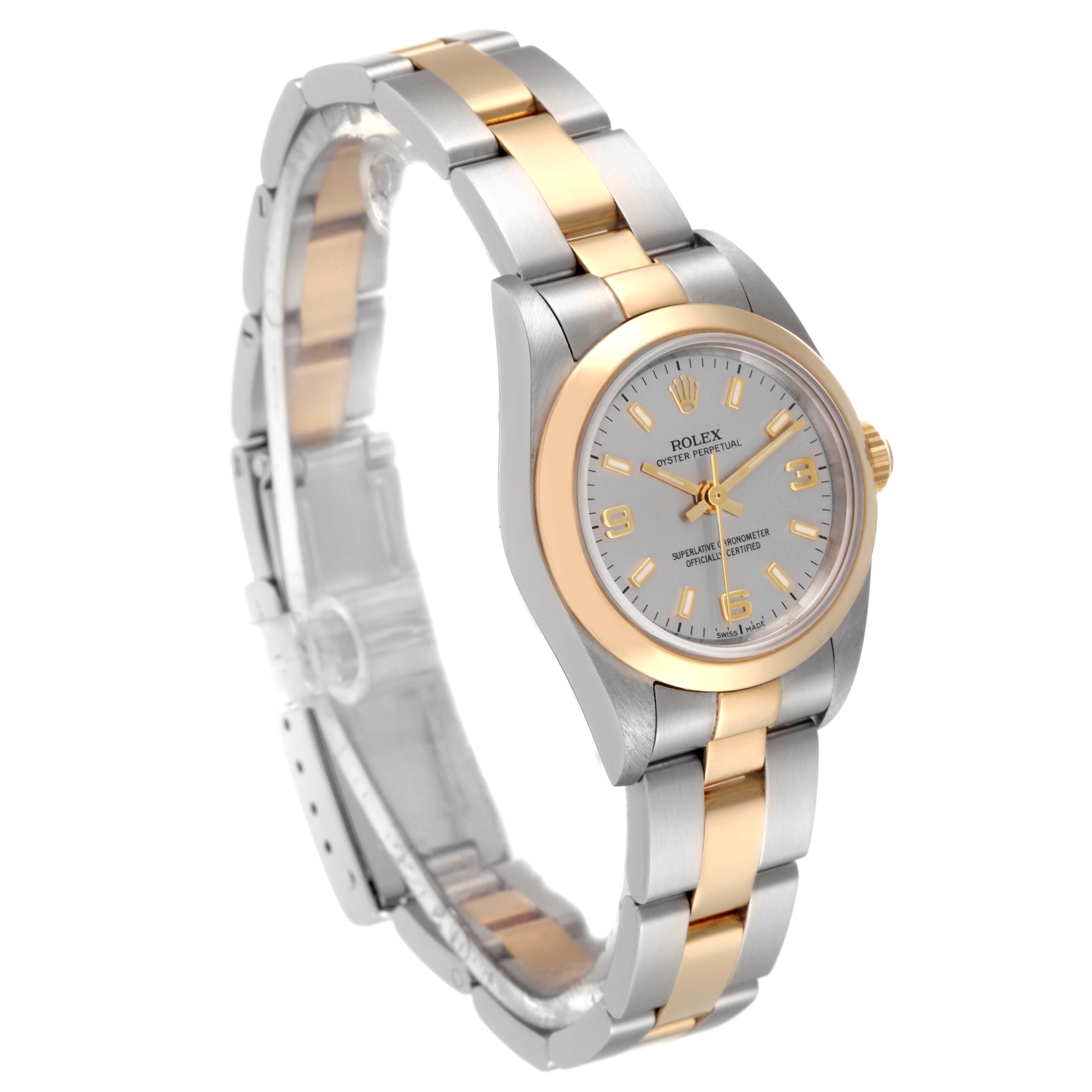 The Rolex Oyster Perpetual 76183 Women's Steel and Gold (two tone) Grey Dial 76183 Women's Steel and Gold (two tone) Grey Dial watch is shown at a three-quarter angle, highlighting its two-tone bracelet and case, and silver dial.