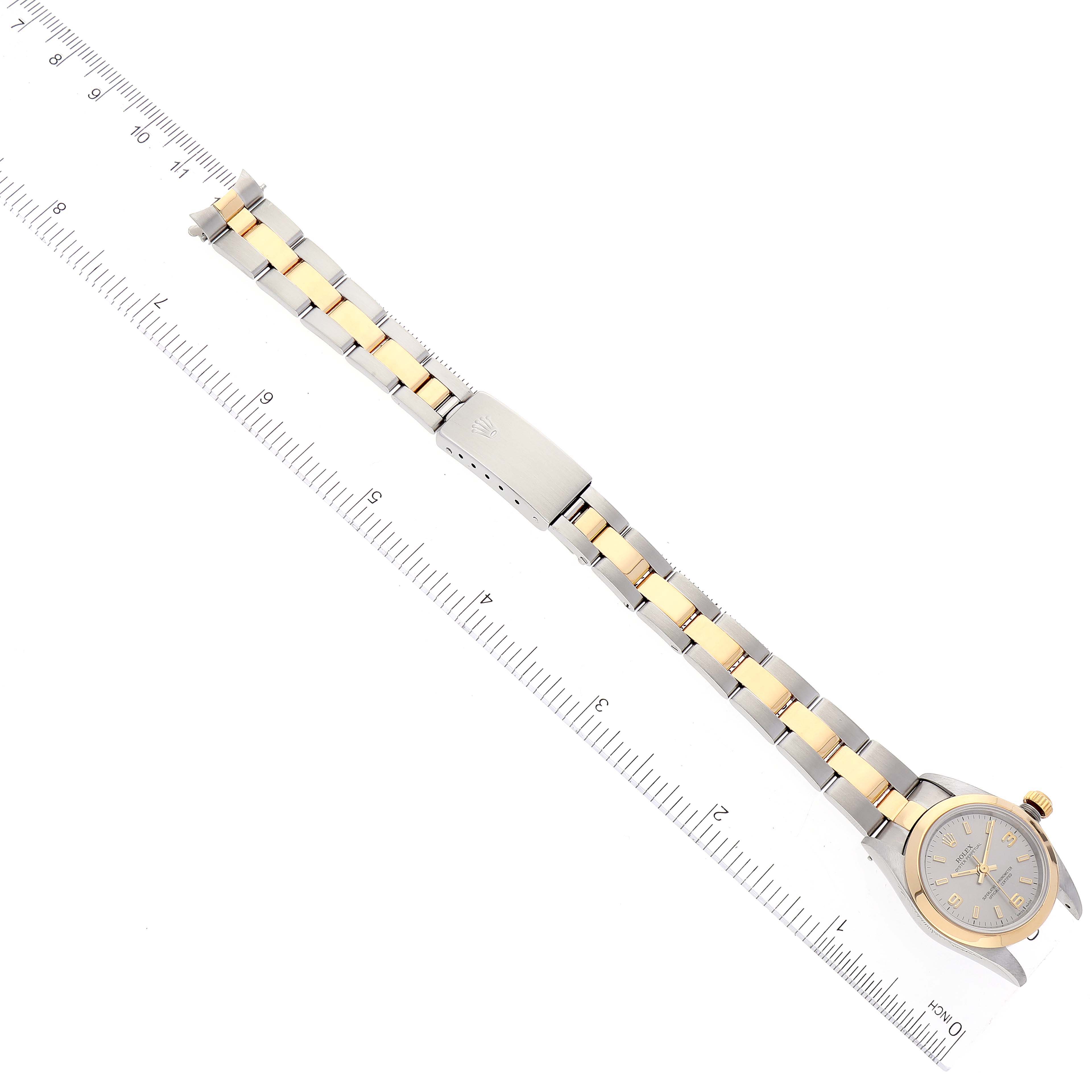 The image shows a Rolex Oyster Perpetual 76183 Women's Steel and Gold (two tone) Grey Dial 76183 Women's Steel and Gold (two tone) Grey Dial watch laid flat with its full bracelet and clasp visible, angled slightly sideways.