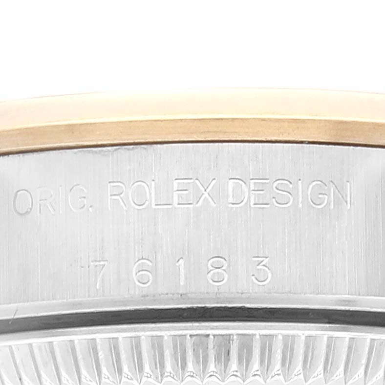 The image shows a close-up of the side of a Rolex Oyster Perpetual 76183 Women's Steel and Gold (two tone) Grey Dial 76183 Women's Steel and Gold (two tone) Grey Dial watch, highlighting the engraved brand name and model number.