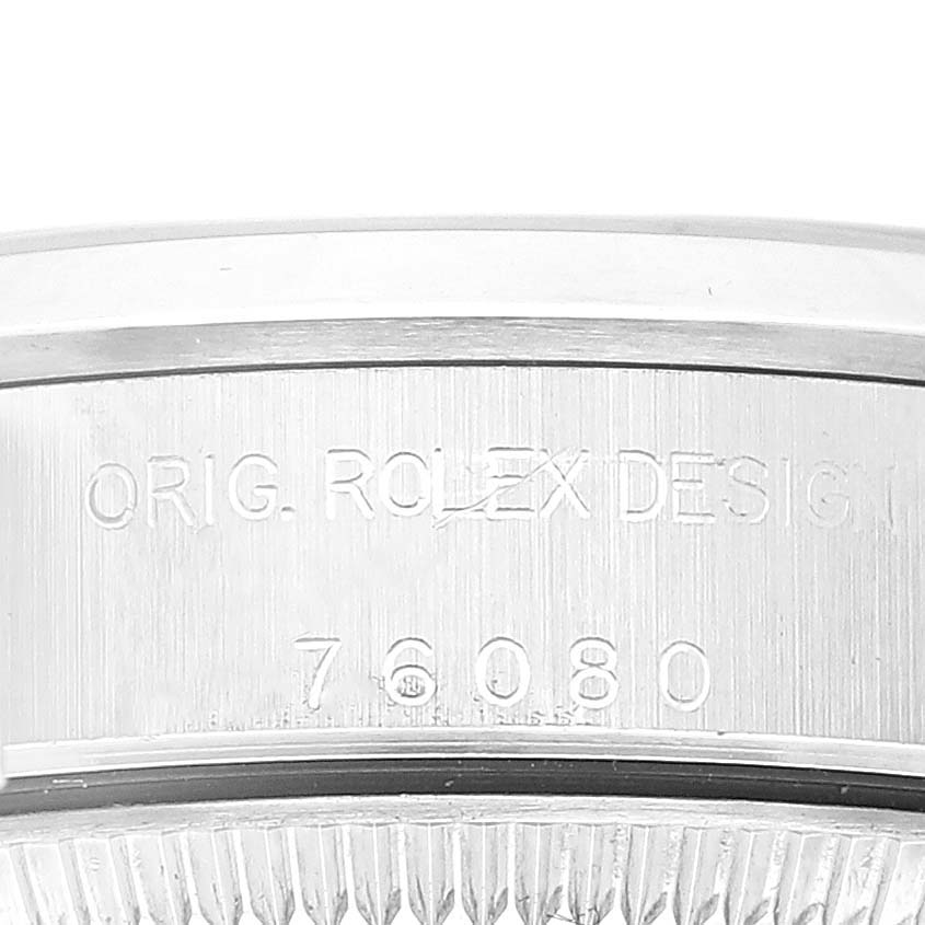 The image shows a close-up of the casing
s side, displaying the engraved text on a Rolex Oyster Perpetual 76080 Women
s Stainless Steel Pink Dial 76080 Women
s Stainless Steel Pink Dial watch.