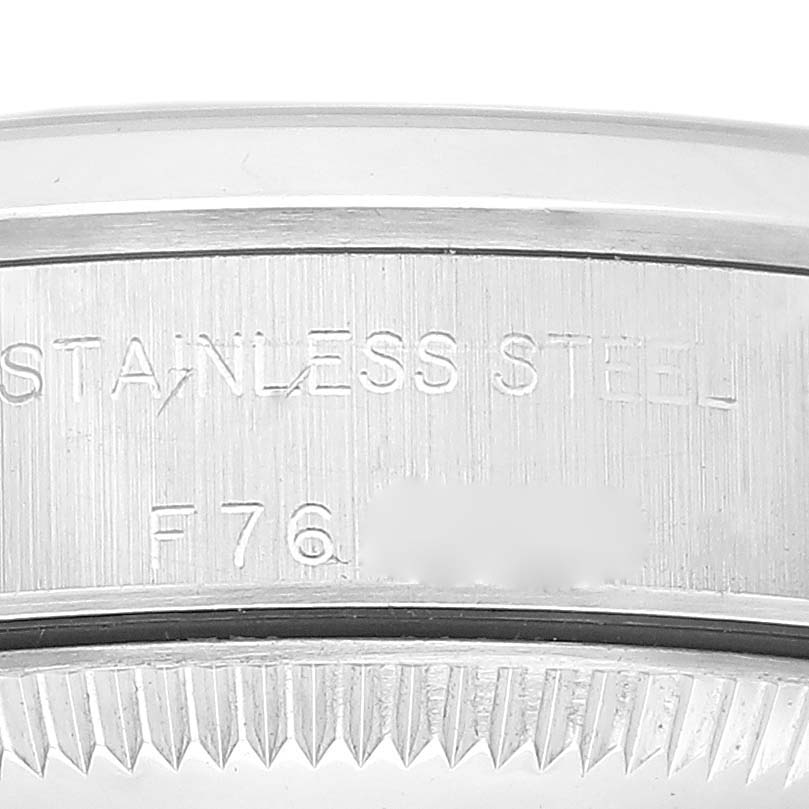 The image shows a close-up of the case back and engraved text on the Rolex Oyster Perpetual 76080 Women
s Stainless Steel Pink Dial 76080 Women
s Stainless Steel Pink Dial watch.