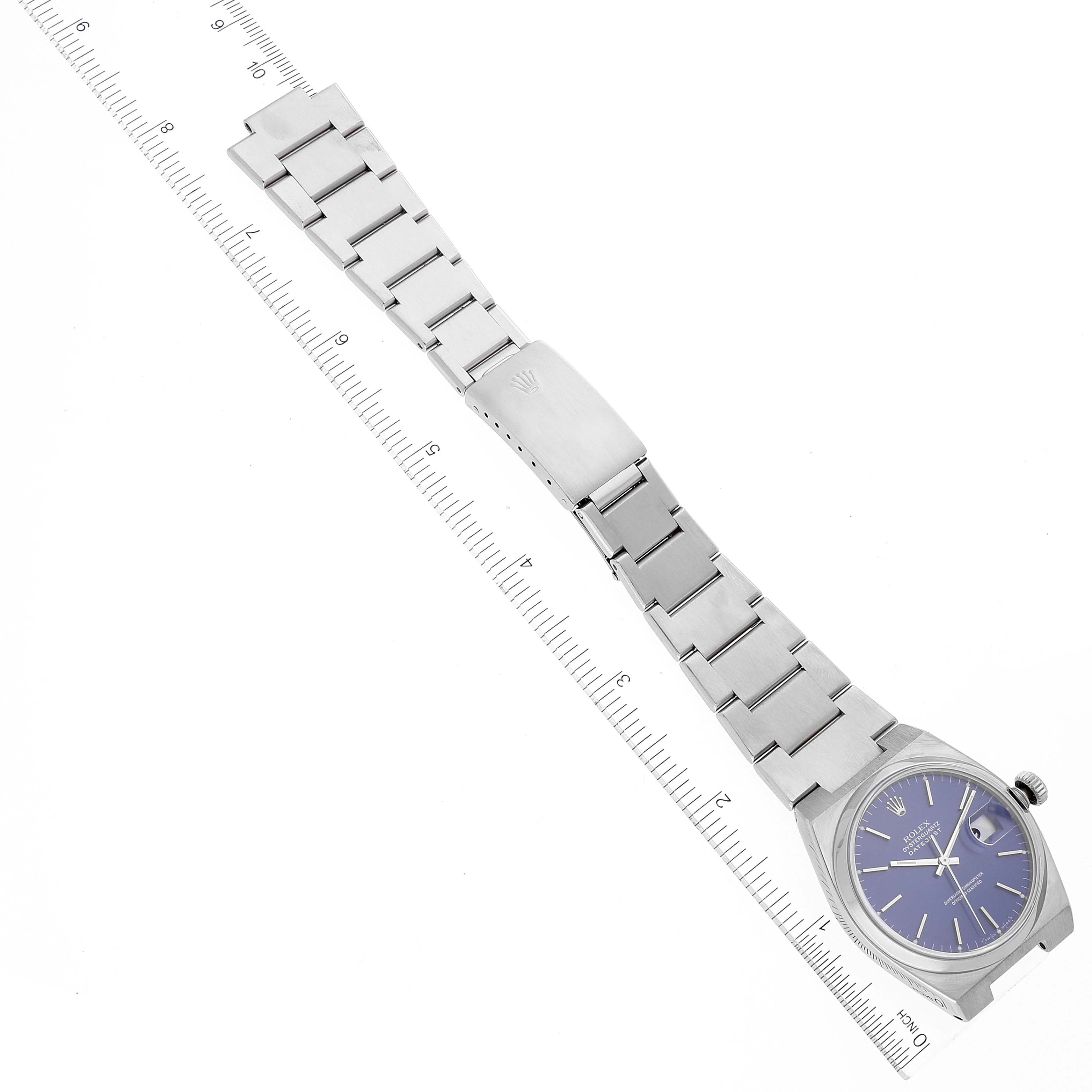 The Rolex Oysterquartz 17000 Men's Stainless Steel Blue Dial 17000 Men's Stainless Steel Blue Dial watch is shown from a top-down angle, including the bracelet, clasp, and face with a ruler for scale.
