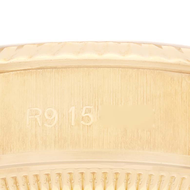 This close-up image shows the engraved serial number on the gold case of the Rolex President 69178 Women's Yellow Gold Champagne Dial 69178 Women's Yellow Gold Champagne Dial model watch.