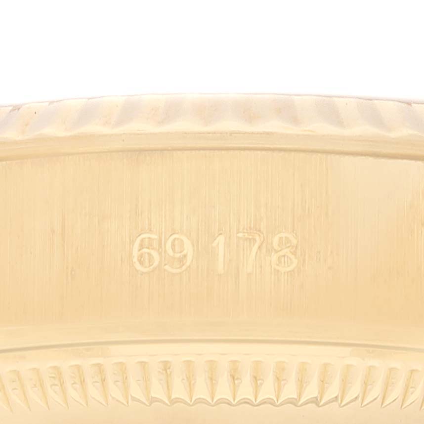 Close-up of the side of a Rolex President 69178 Women's Yellow Gold Champagne Dial 69178 Women's Yellow Gold Champagne Dial model watch, showing engraved numbers and edge detailing.