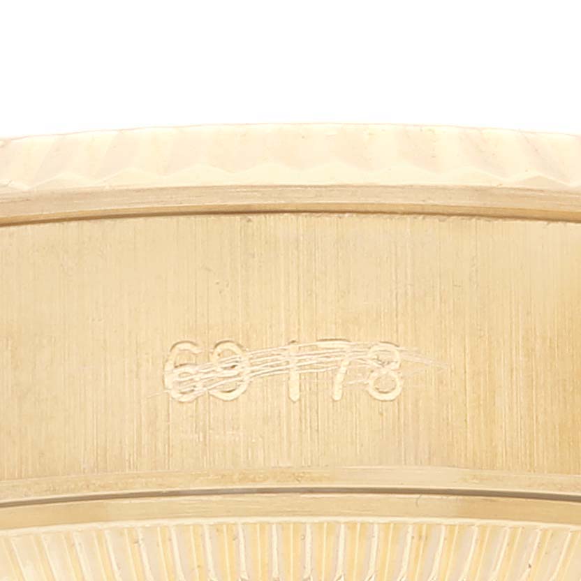 The image shows a close-up of the side view of the bezel and case of a Rolex President 69178 Women
s Yellow Gold Champagne Dial 69178 Women
s Yellow Gold Champagne Dial model watch.