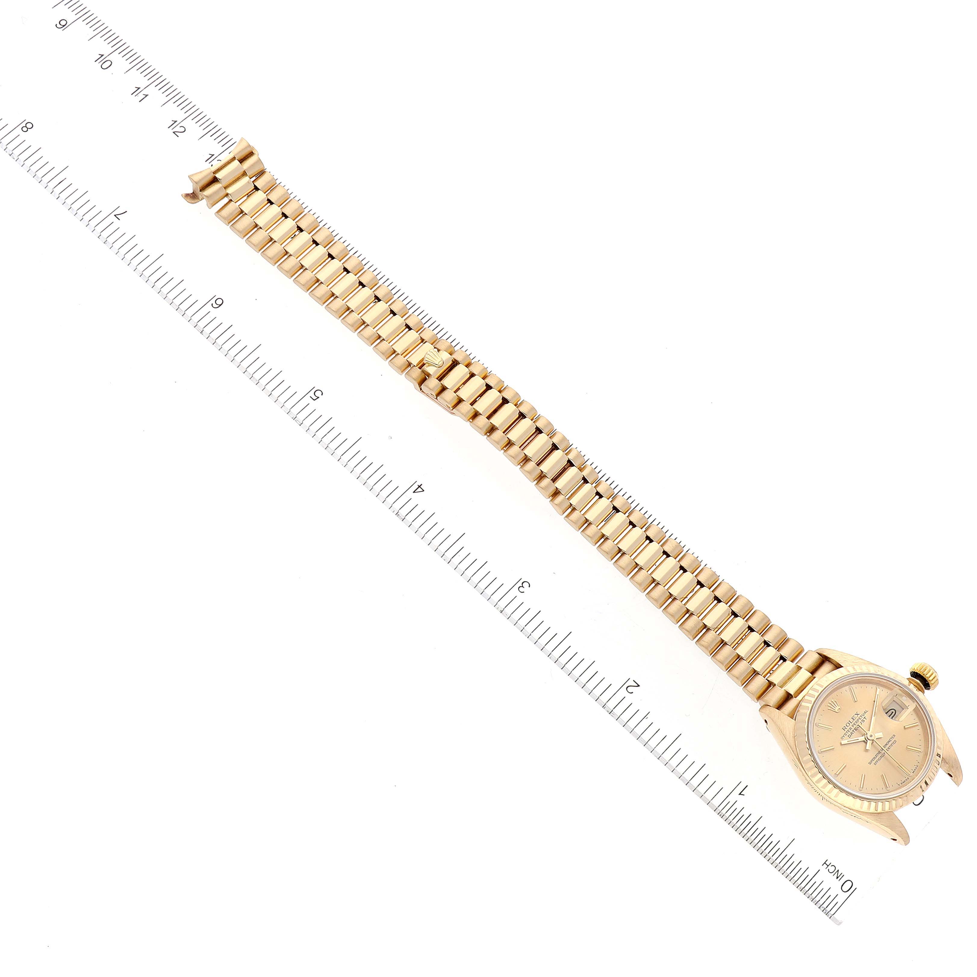 The image shows a Rolex President 69178 Women's Yellow Gold Champagne Dial 69178 Women's Yellow Gold Champagne Dial model watch laid flat, both case and gold bracelet visible, with a ruler for scale.