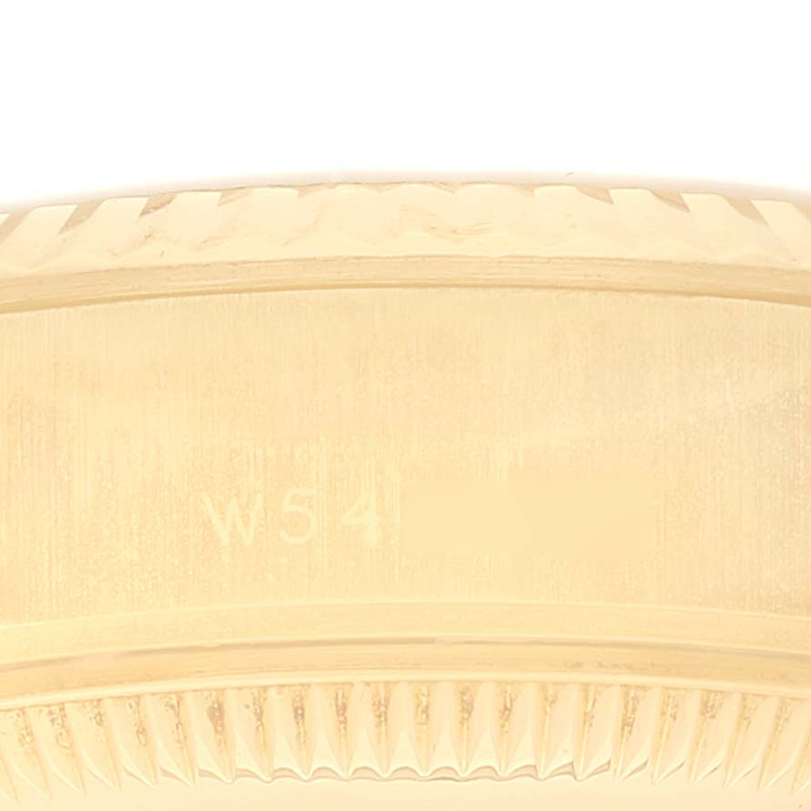 This is a close-up of the side view of the Rolex President 69178 Women's Yellow Gold Champagne Dial 69178 Women's Yellow Gold Champagne Dial model showing the detailed bezel and engraved markings.