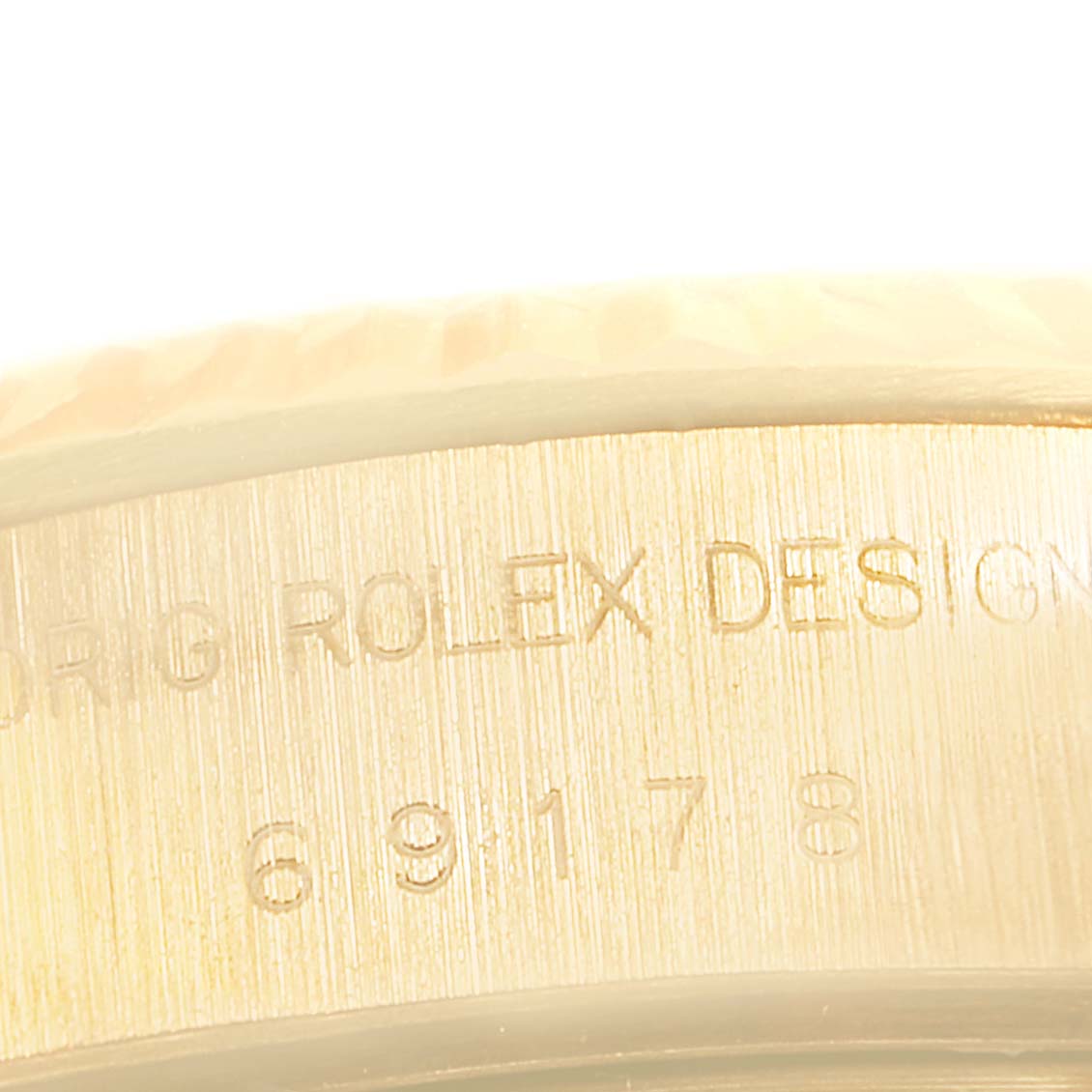 The image shows a close-up of the side engraving on a Rolex President 69178 Women's Yellow Gold Champagne Dial 69178 Women's Yellow Gold Champagne Dial model watch.