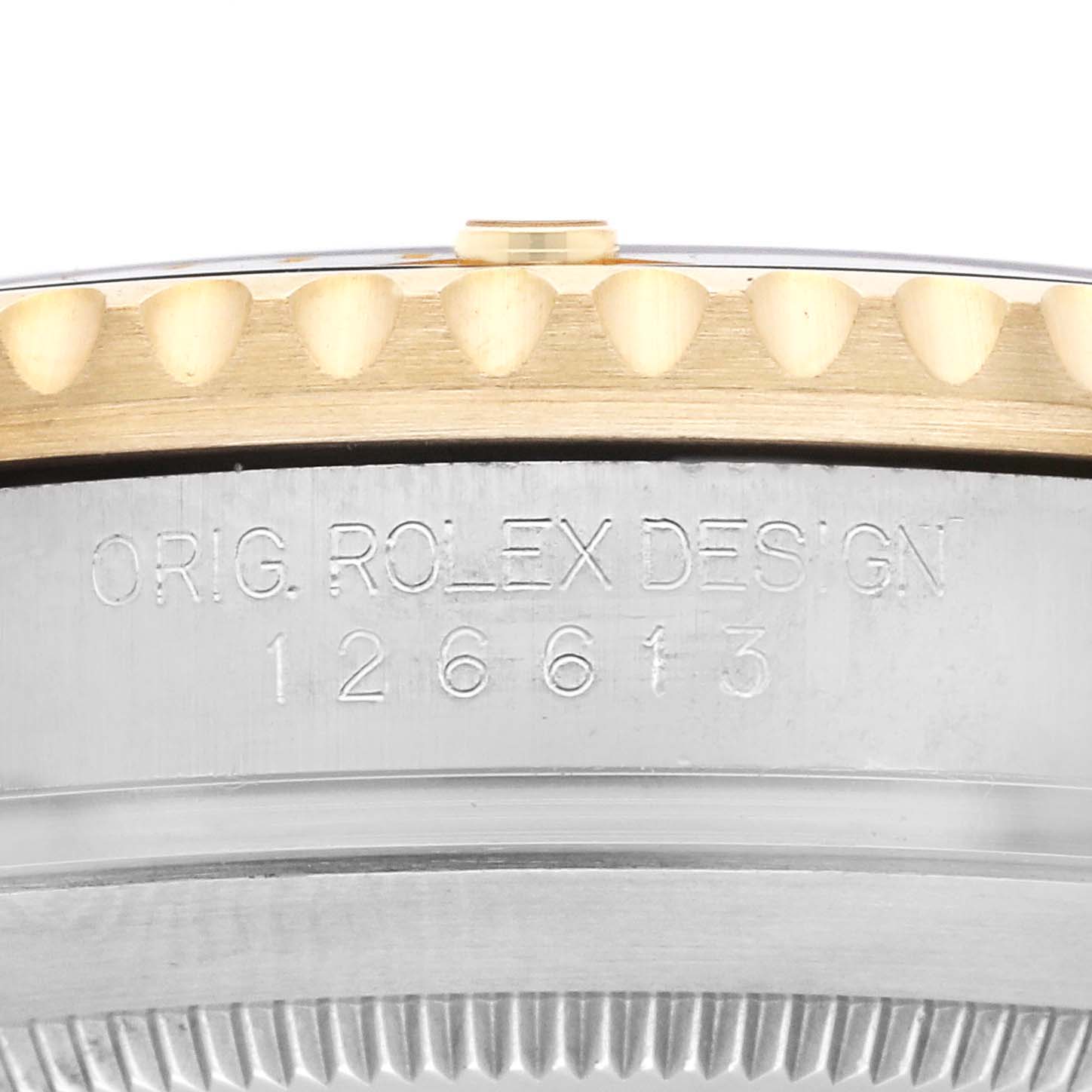 The image shows a close-up of the side of the Rolex Submariner 126613LN Men's Steel and Gold (two tone) Black Dial 126613LN Men's Steel and Gold (two tone) Black Dial's bezel and case, featuring the "ORIG. ROLEX DESIGN" engraving.