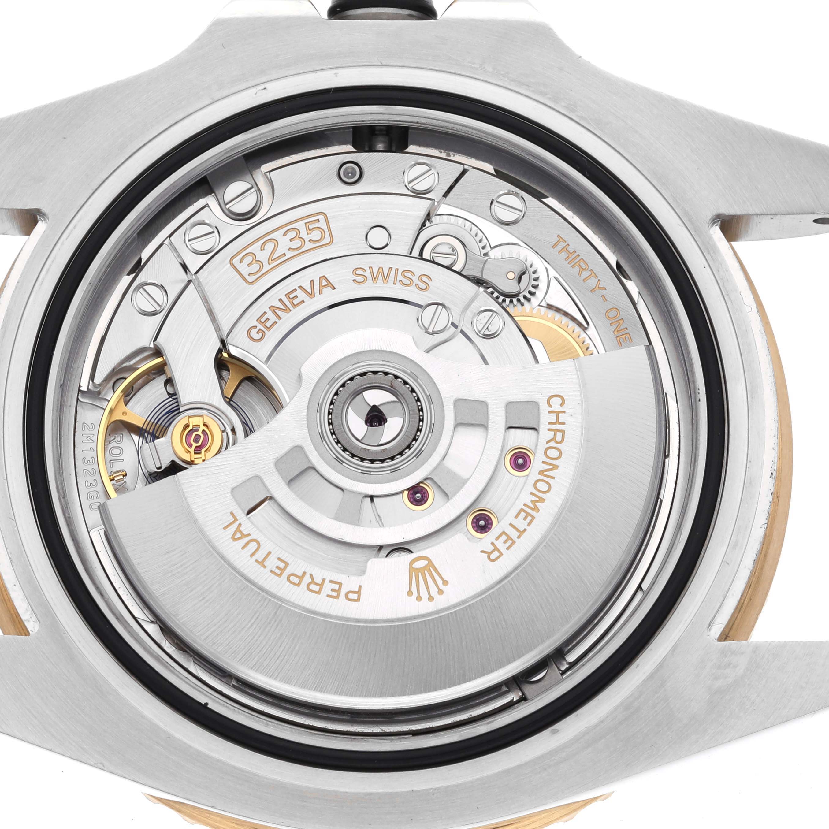 The image shows the back view of the Rolex Submariner 126613LN Men's Steel and Gold (two tone) Black Dial 126613LN Men's Steel and Gold (two tone) Black Dial, highlighting its movement and inner mechanisms.