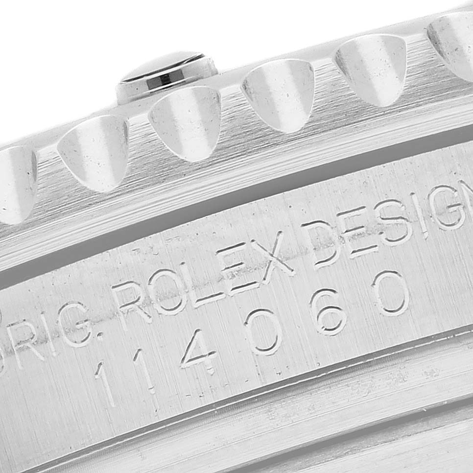 This close-up image shows part of the bezel and the case's engraved model number of a Rolex Submariner 114060 Men's Stainless Steel Black Dial 114060 Men's Stainless Steel Black Dial watch.