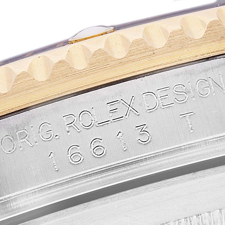 The close-up image shows the engraved case side and part of the bezel of a Rolex Submariner 16613 Men's Steel and Gold (two tone) Blue Dial 16613 Men's Steel and Gold (two tone) Blue Dial watch.
