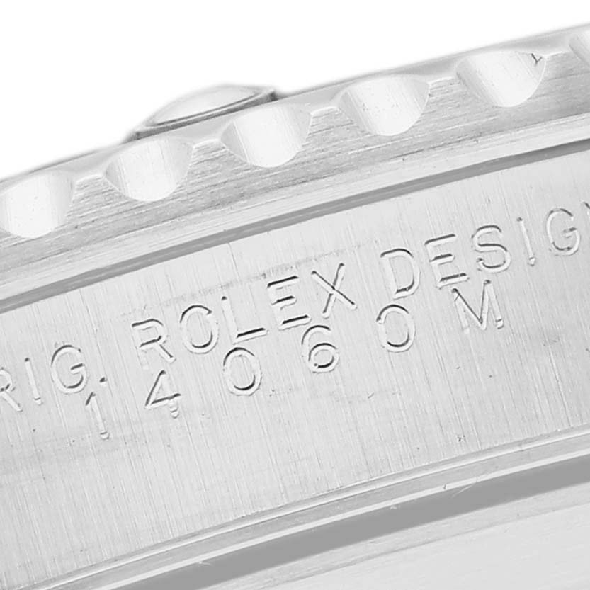 The image shows a close-up of the side of the bezel and casing of a Rolex Submariner 14060M Men
s Stainless Steel Black Dial 14060M Men
s Stainless Steel Black Dial watch, highlighting the engraved model number.