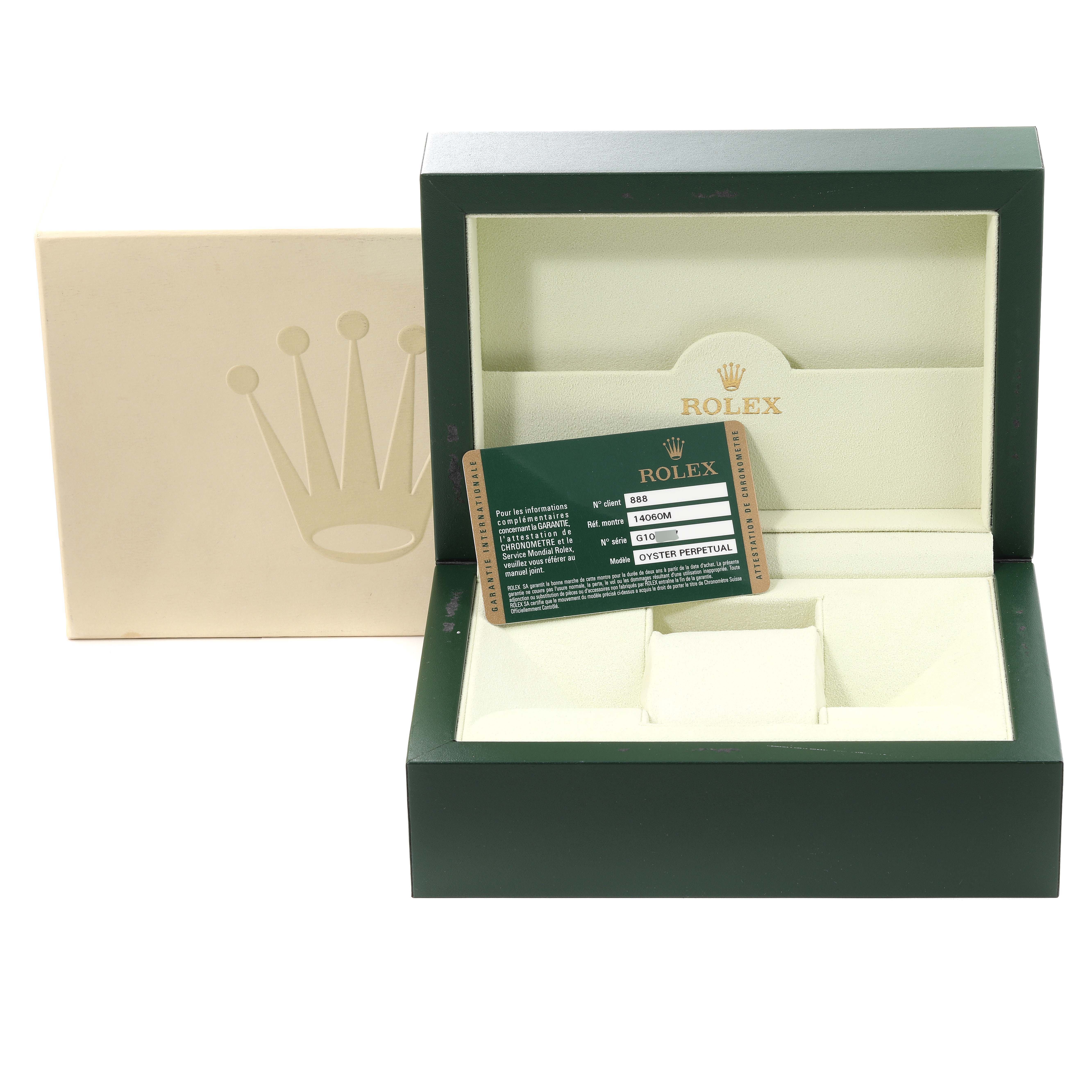The image shows an empty Rolex Submariner 14060M Men
s Stainless Steel Black Dial 14060M Men
s Stainless Steel Black Dial watch box with its warranty card and outer packaging.