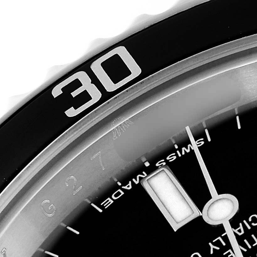 This close-up image shows a portion of the bezel, dial, and hands of a Rolex Submariner 14060M Men
s Stainless Steel Black Dial 14060M Men
s Stainless Steel Black Dial watch.