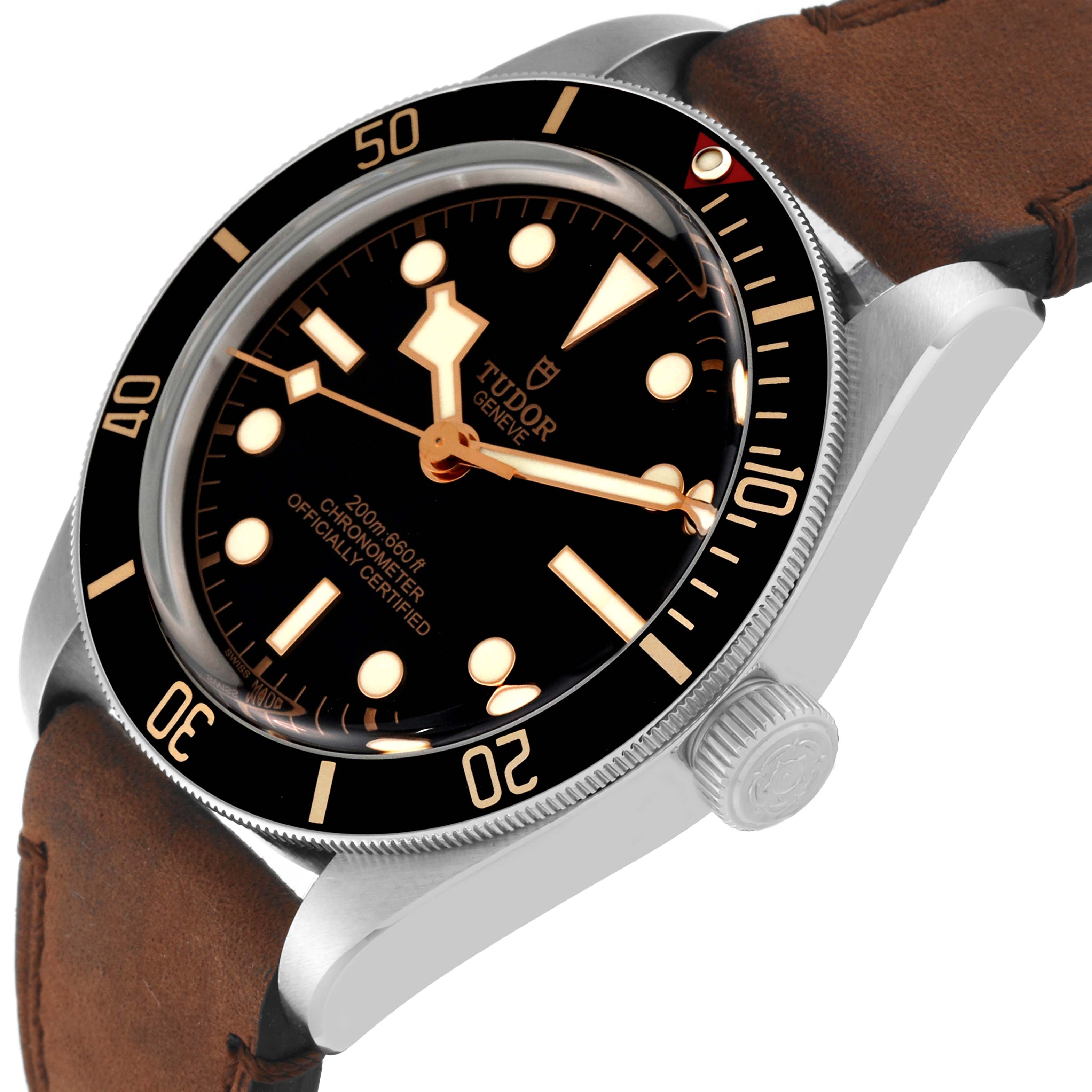 The image shows a Tudor Heritage Black Bay M79030N-0001 Men
s Stainless Steel Black Dial M79030N-0001 Men
s Stainless Steel Black Dial watch from an angled view, highlighting the face, bezel, crown, and brown leather strap.