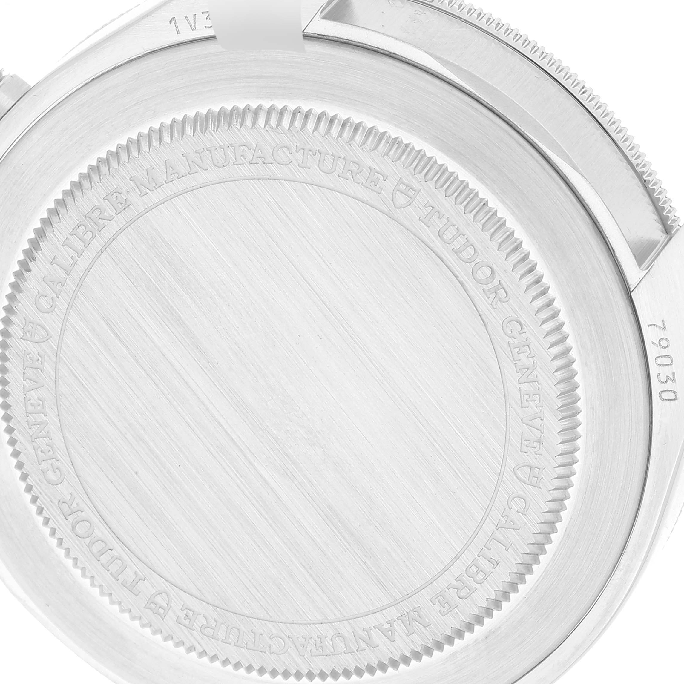 The image shows the case back of a Tudor Heritage Black Bay 79030B Men's Stainless Steel Blue Dial 79030B Men's Stainless Steel Blue Dial watch with engravings and a partially visible serial number.