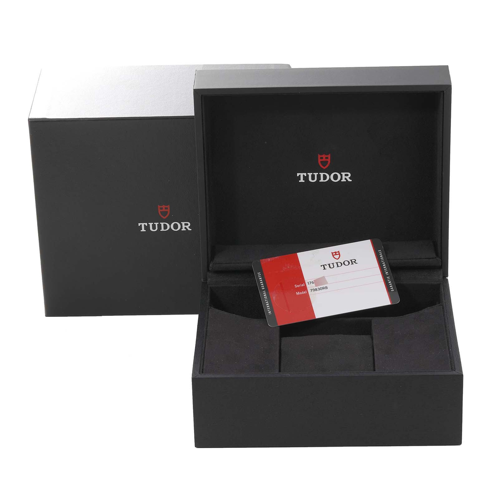 The image shows the open box for the Tudor Heritage Black Bay 79830RB Men
s Stainless Steel Black Dial 79830RB Men
s Stainless Steel Black Dial watch, revealing the packaging and warranty card.