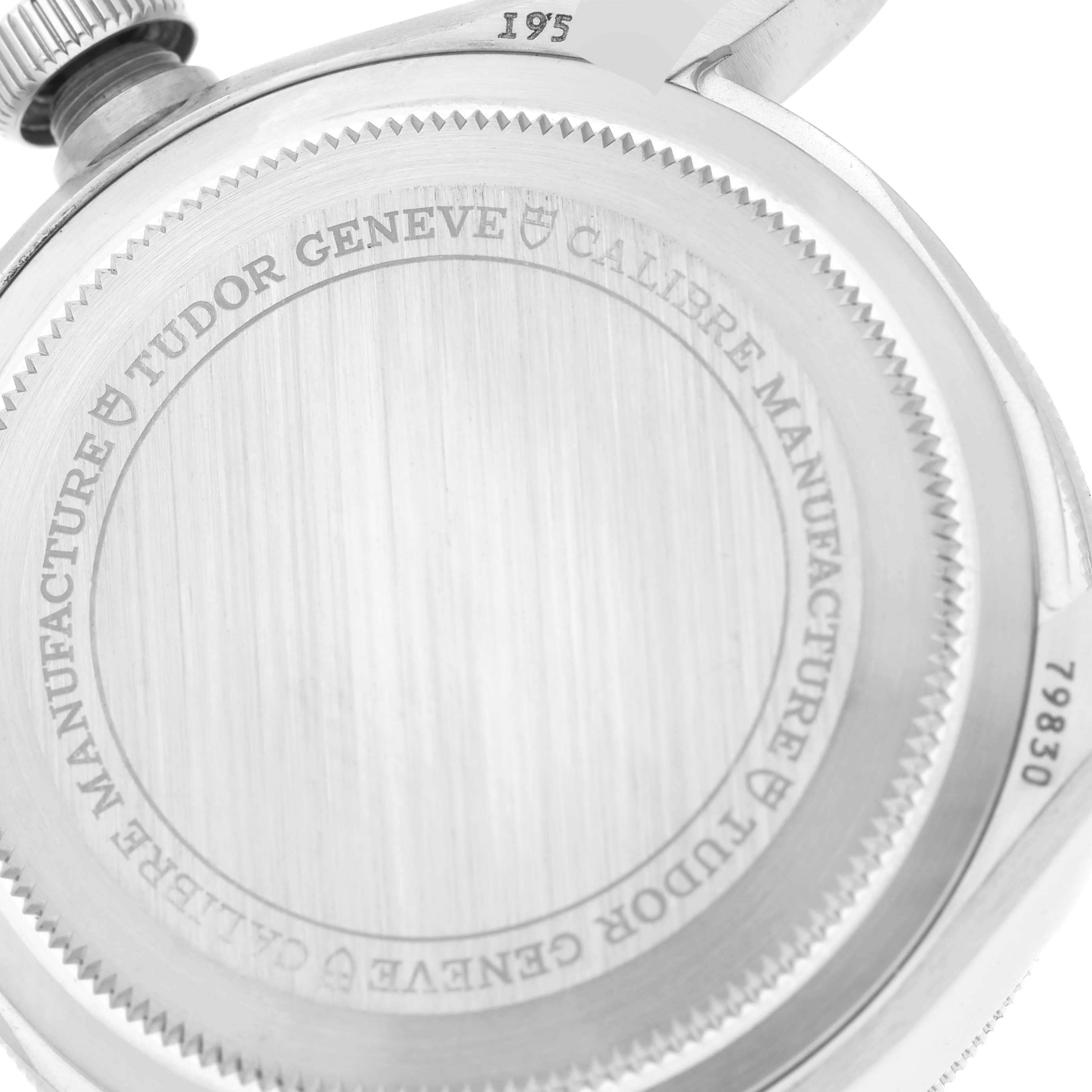 This image shows the back case and crown of a Tudor Heritage Black Bay 79830RB Men
s Stainless Steel Black Dial 79830RB Men
s Stainless Steel Black Dial watch, highlighting the engraved text and serial number.