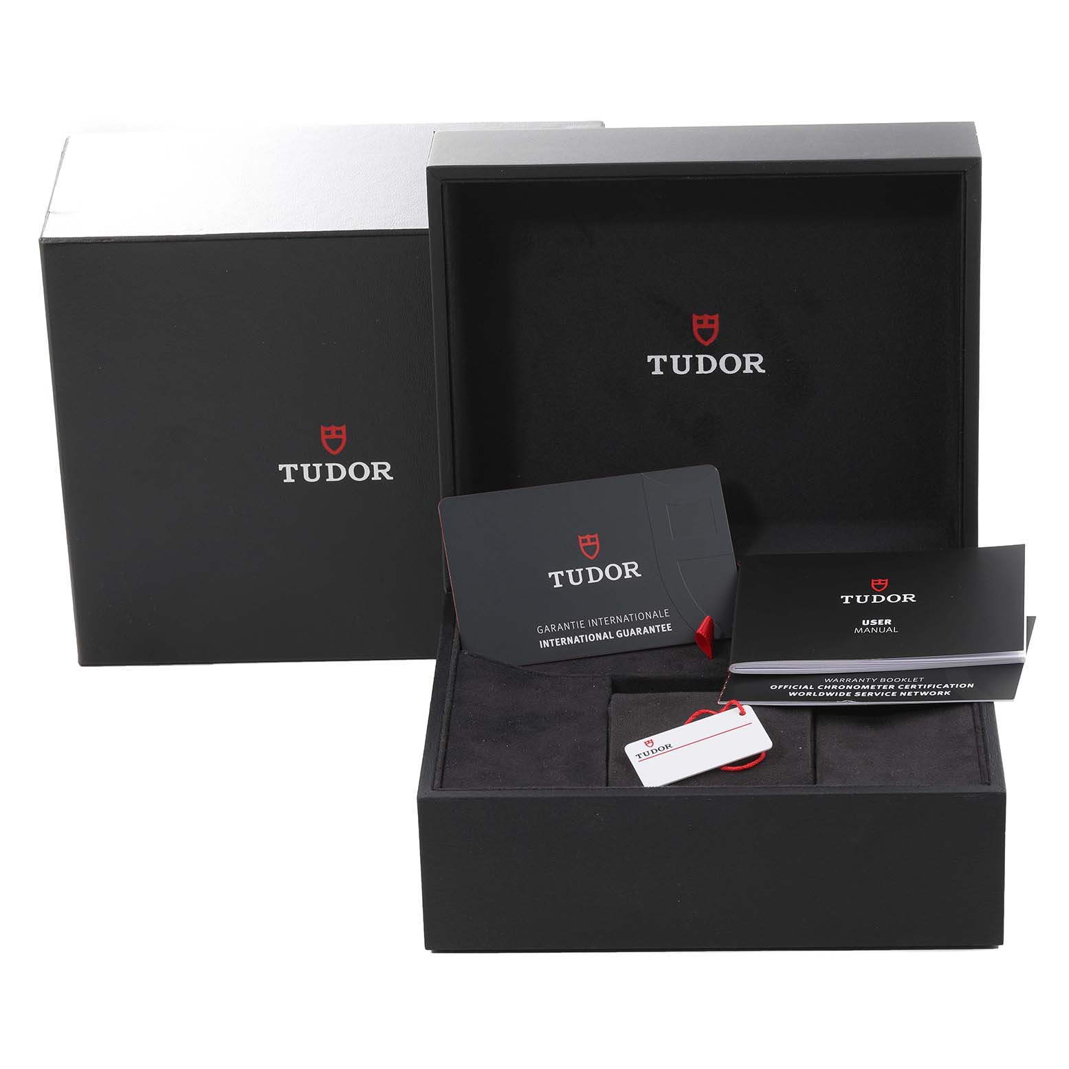 The image shows the packaging, international guarantee card, user manual, and tag of a Tudor Heritage Black Bay 79830RB Men
s Stainless Steel Black Dial 79830RB Men
s Stainless Steel Black Dial watch.