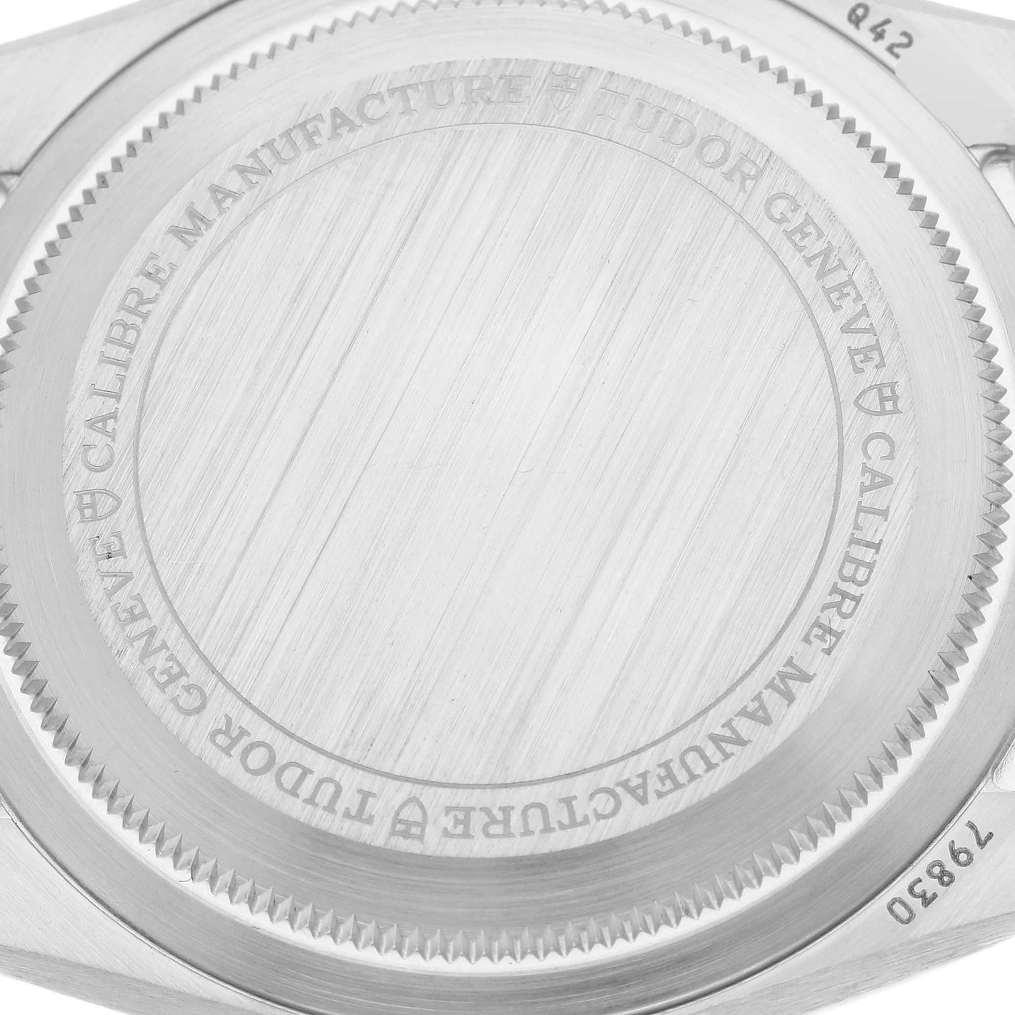 The image shows the case back of a Tudor Heritage Black Bay 79830RB Men
s Stainless Steel Black Dial 79830RB Men
s Stainless Steel Black Dial watch viewed from a close-up angle.