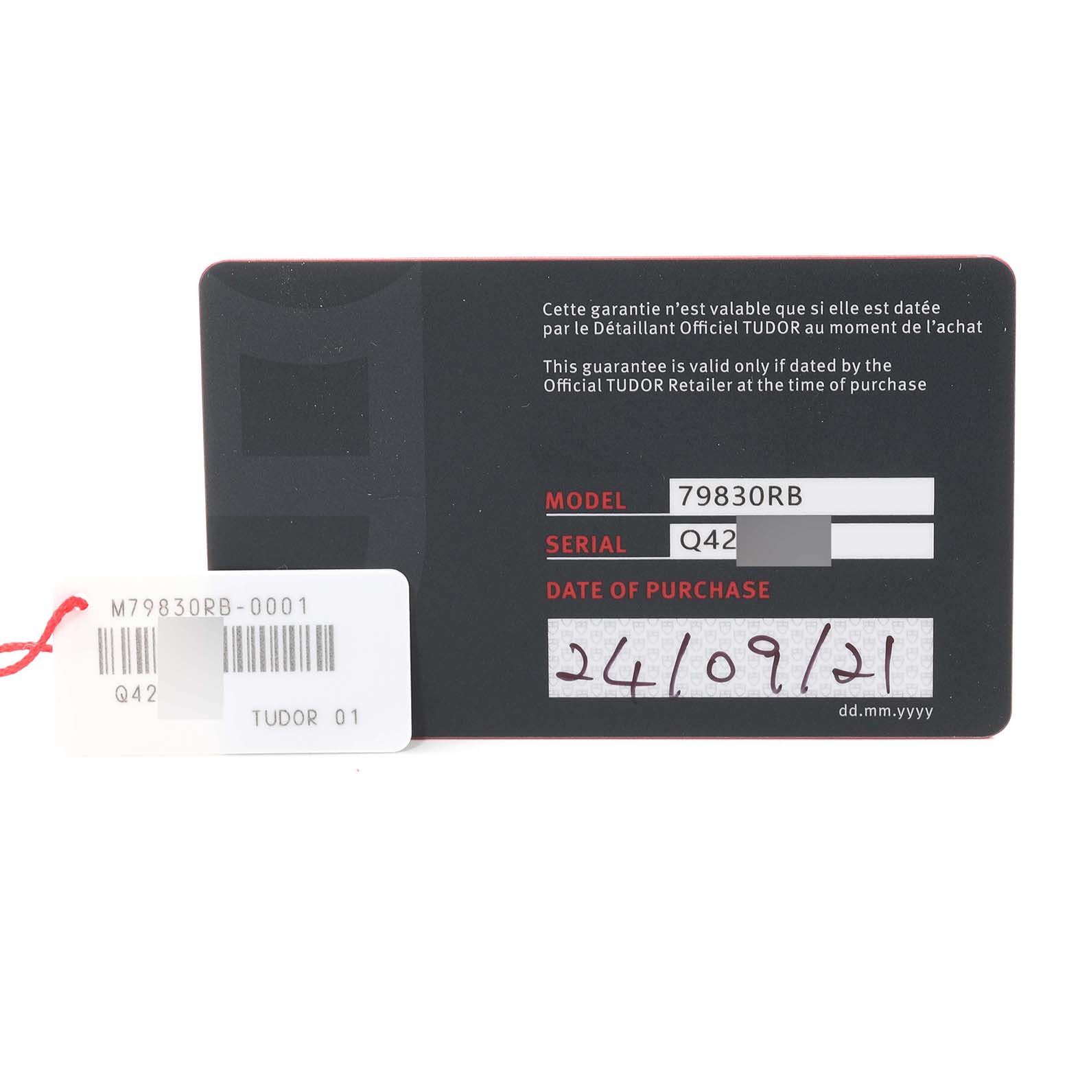 The image shows a warranty card and tag for the Tudor Heritage Black Bay 79830RB Men
s Stainless Steel Black Dial 79830RB Men
s Stainless Steel Black Dial model, including the model number, serial number, and date of purchase.