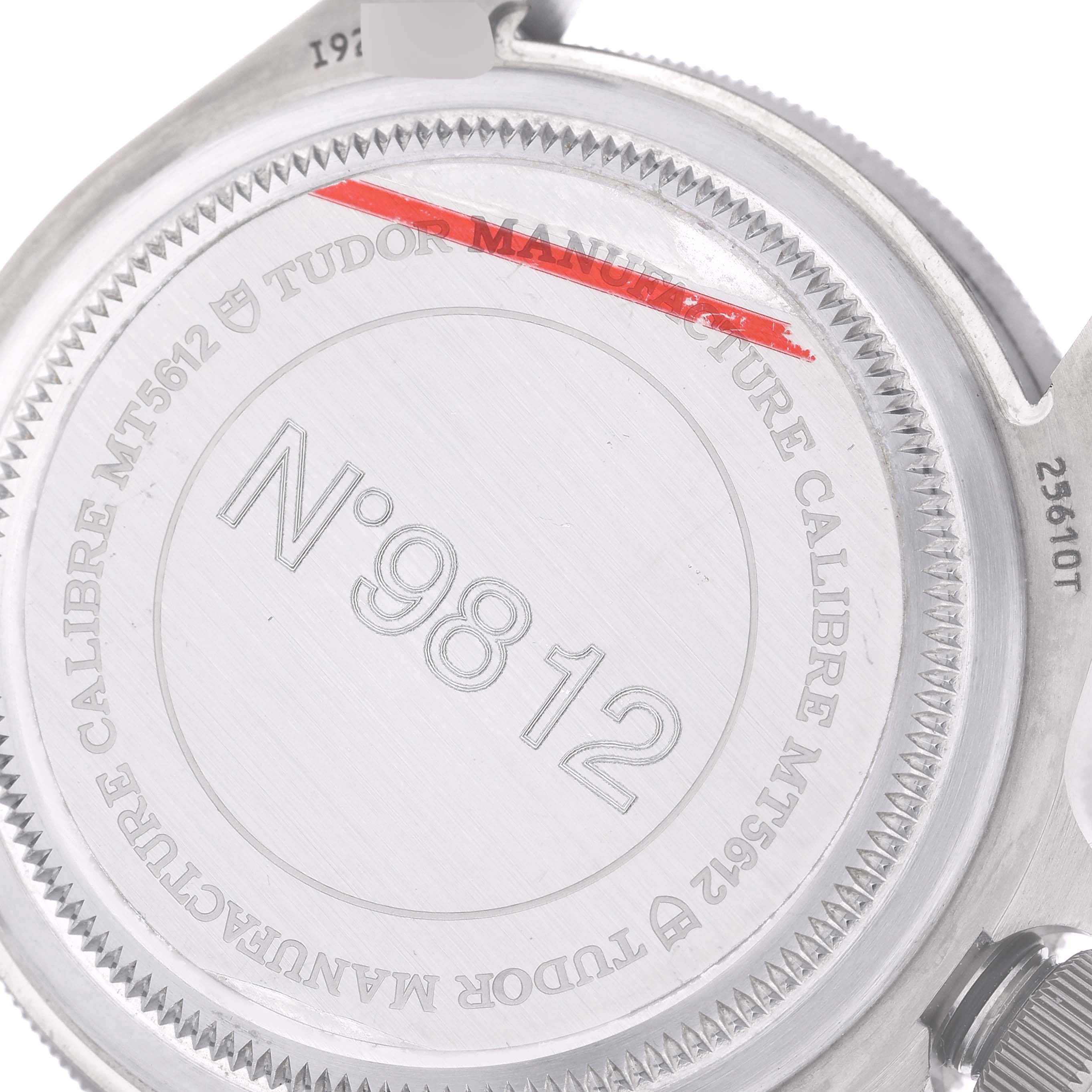 The image displays the case back of a Tudor Pelagos 25610TNL Men
s Titanium Black Dial 25610TNL Men
s Titanium Black Dial watch, showing engravings and the model number MT5612.