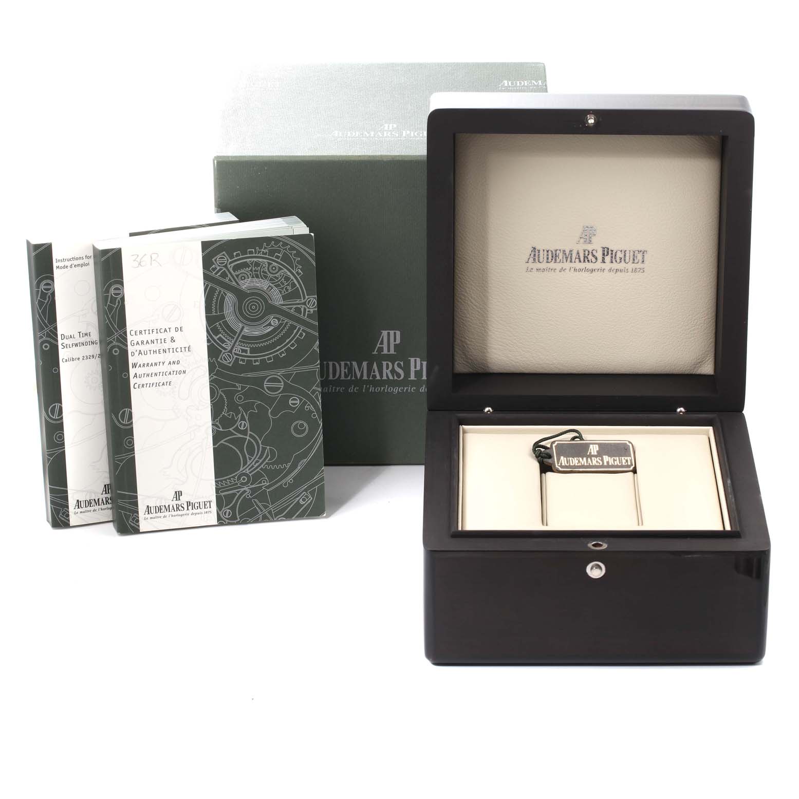 The image shows packaging accessories for an Audemars Piguet Royal Oak 26120ST.00.1220ST.03 Men's Stainless Steel Black Dial 26120ST.00.1220ST.03 Men's Stainless Steel Black Dial, including its box, manuals, and warranty certificate.