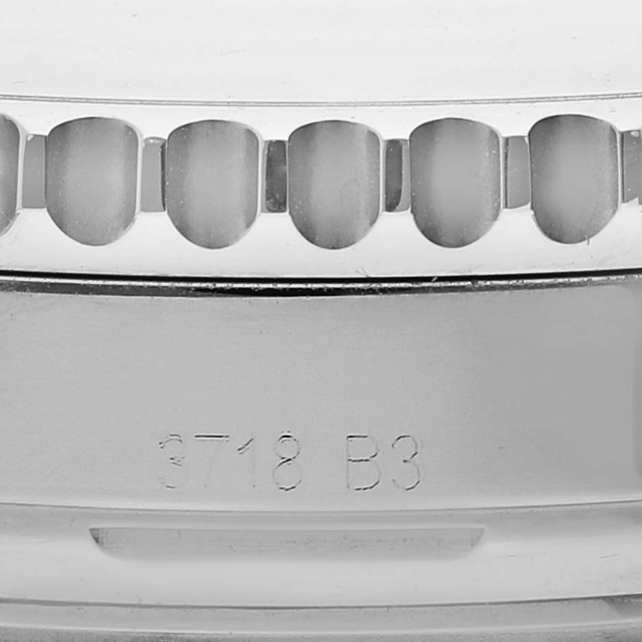 This image shows the textured bezel and engraved case back of a Breitling Navitimer AB0121 Men's Stainless Steel Black Dial AB0121 Men's Stainless Steel Black Dial watch.