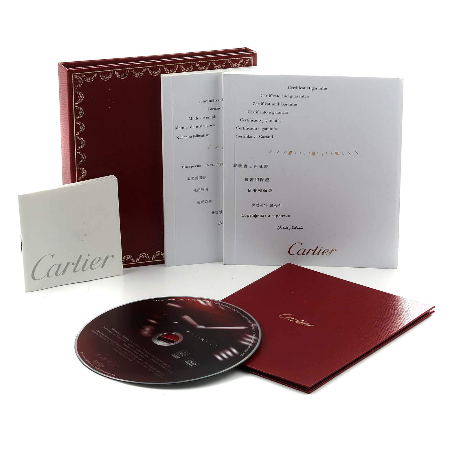 The image shows accessories for the Cartier Ballon Bleu WE902044 Women's Steel and Gold (two tone) Silver Dial watch, including a box, manuals, and a CD, captured from a front angle.