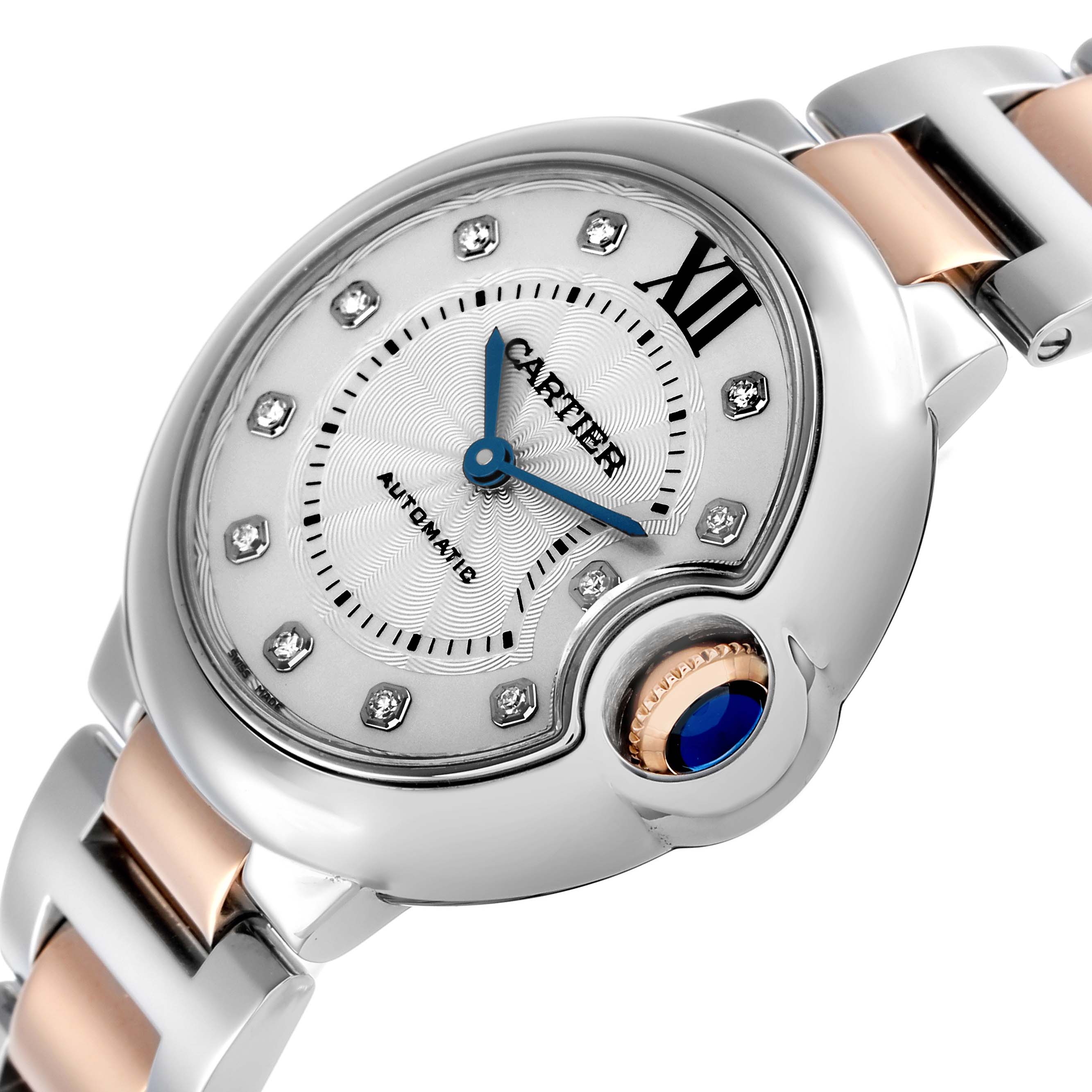 The Cartier Ballon Bleu WE902044 Women's Steel and Gold (two tone) Silver Dial watch is shown at an angled close-up, highlighting its face, blue hands, and the distinctive crown with a blue cabochon.