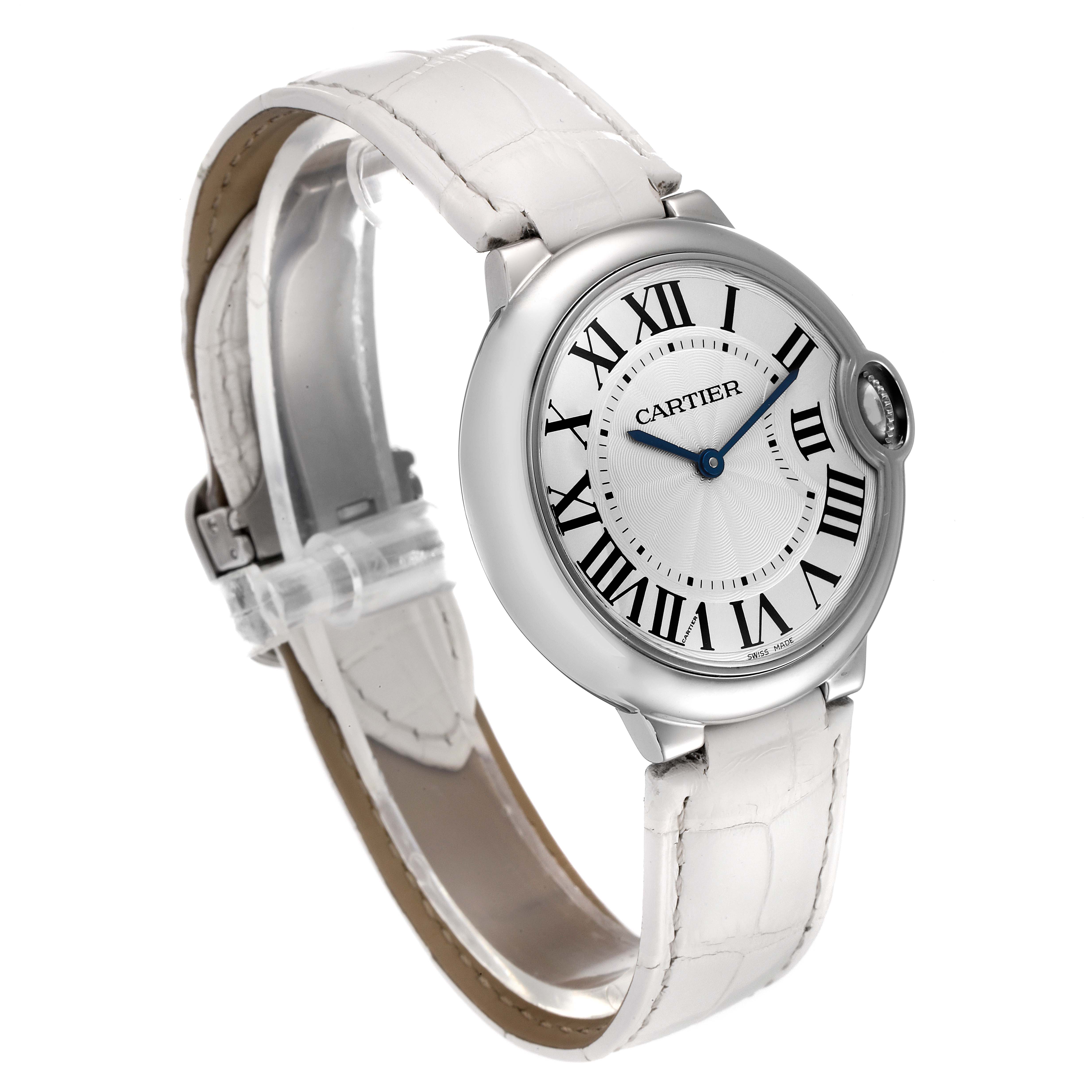 The image shows a Cartier Ballon Bleu W6920087 Women
s Stainless Steel Silver Dial W6920087 Women
s Stainless Steel Silver Dial watch angled from the left-front, highlighting its face, crown, and white leather strap.
