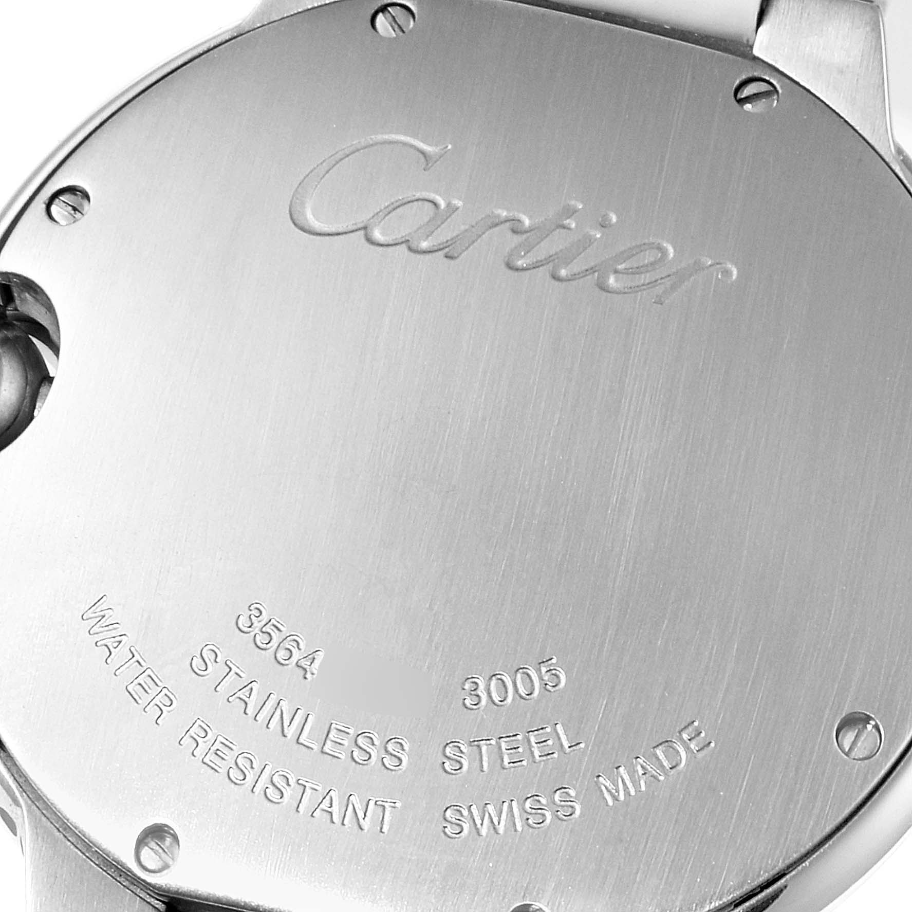 The image shows the back case of a Ballon Bleu model watch by Cartier, highlighting the engraving and material details.