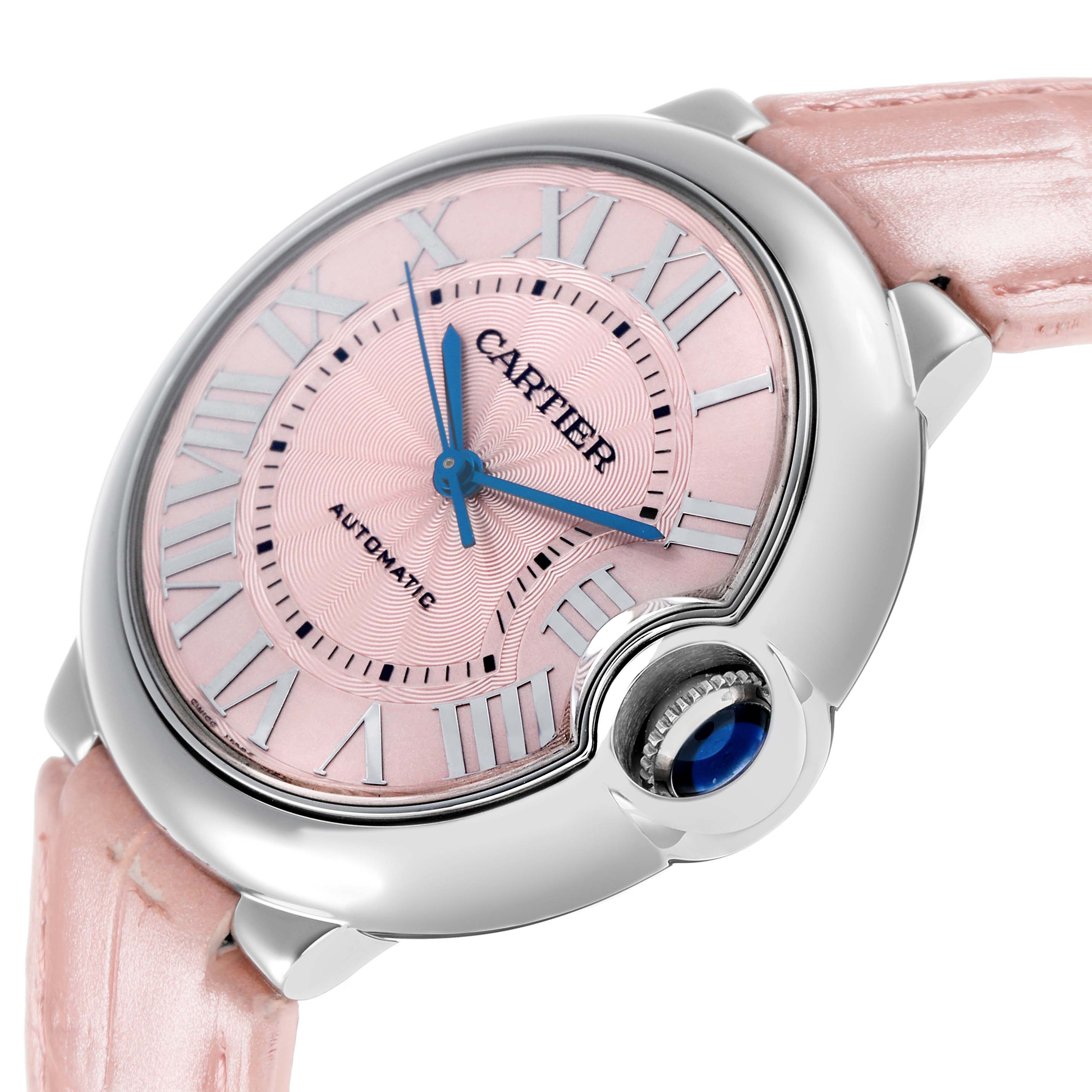 The Cartier Ballon Bleu WSBB0007 Women's Stainless Steel Pink Dial watch is shown at a slight angle, highlighting the pink dial, Roman numerals, and crown with a blue cabochon.
