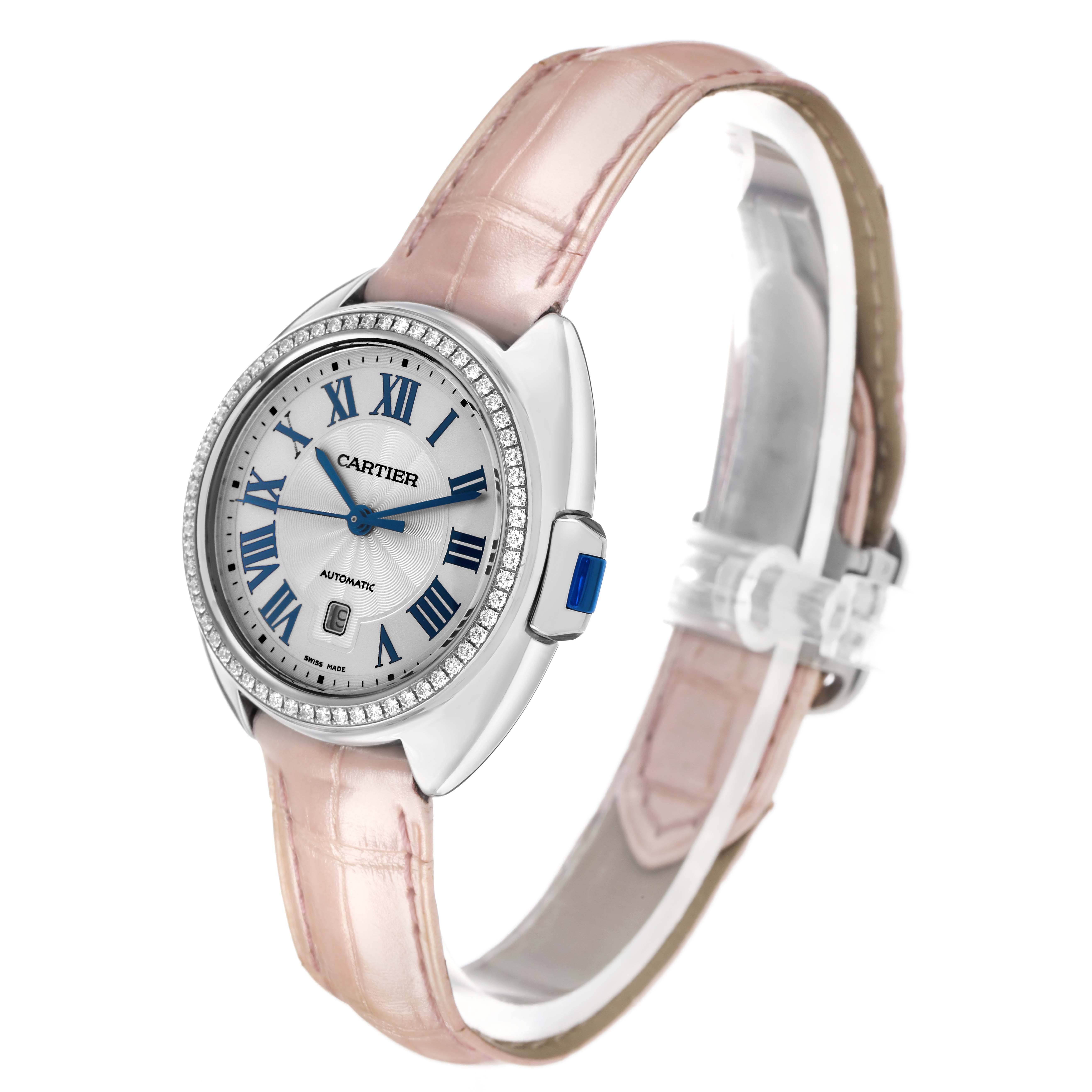 The Cartier Clé watch is shown at a 3/4 angle, displaying the face, bezel, and pink strap.