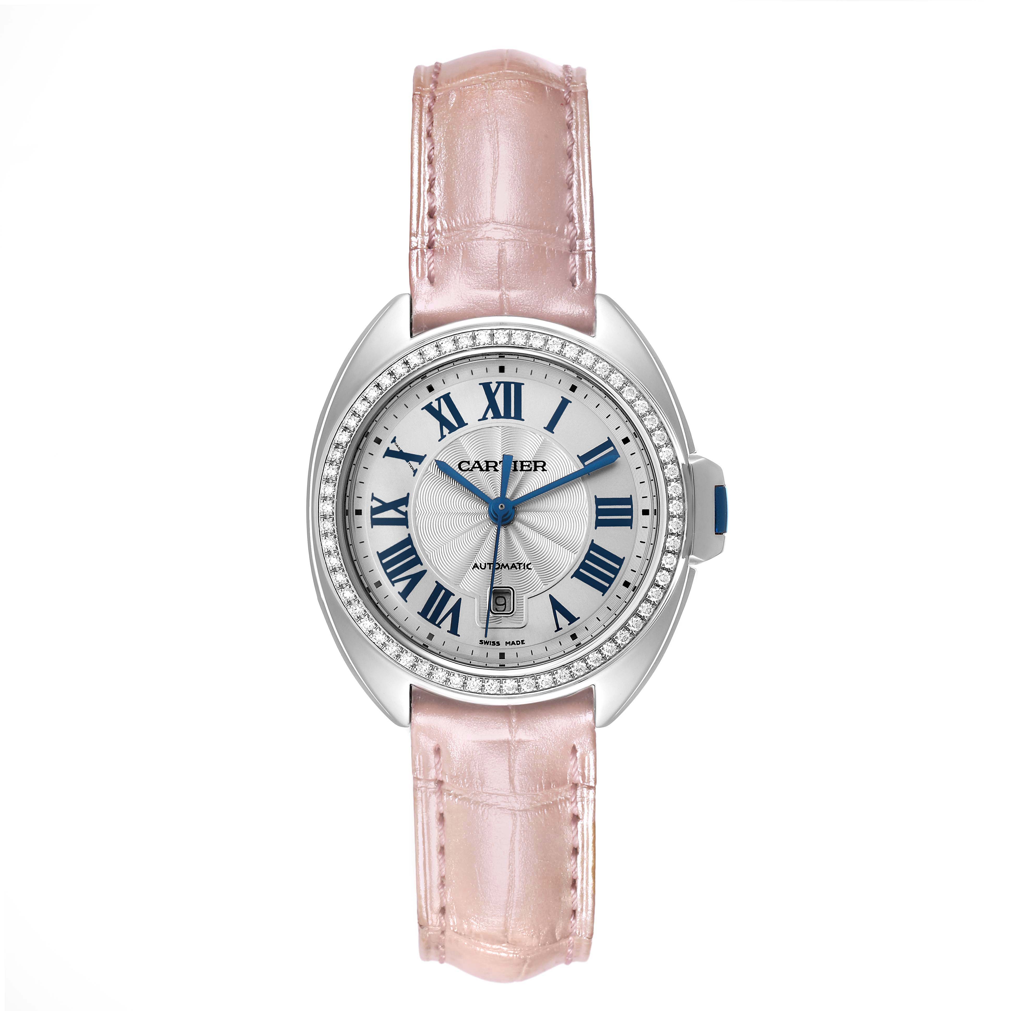 The Cartier Clé watch is shown from the top, highlighting the dial, bezel, crown, and pink strap.