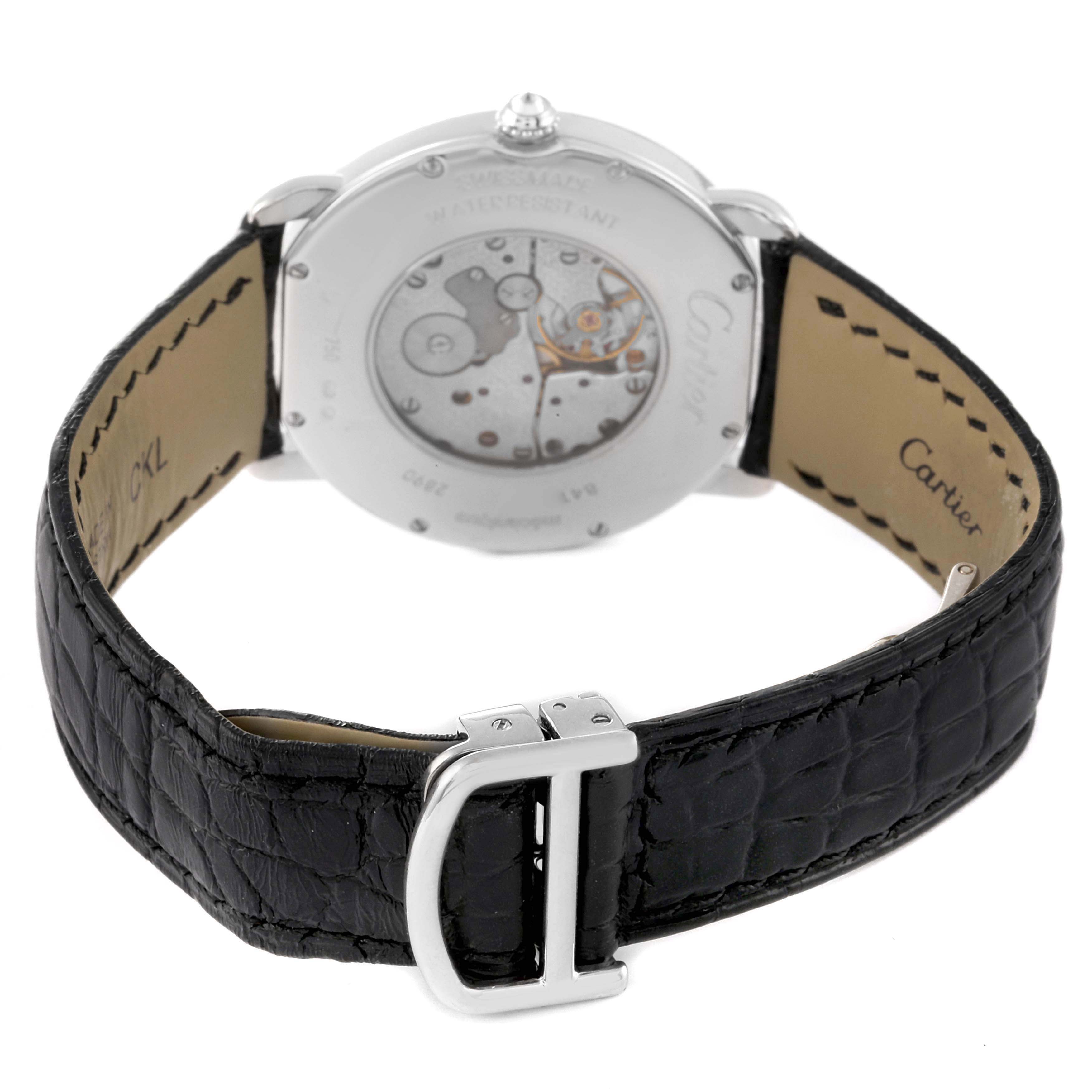 The image shows the back view of a Cartier Ronde WR000551 Women's White Gold Silver Dial watch, highlighting its transparent caseback and black leather strap with a clasp.